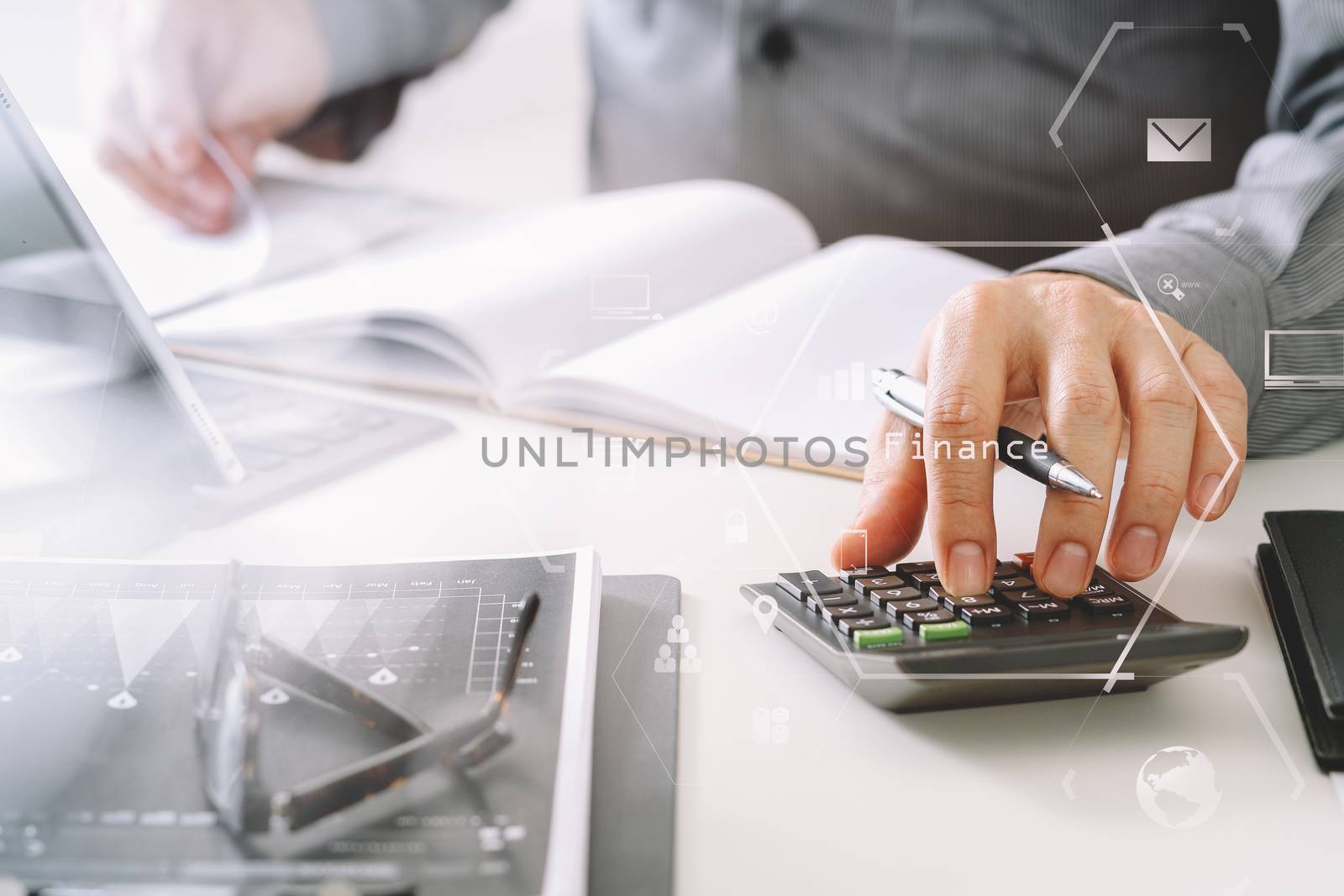 businessman hand working with finances about cost and calculator and latop with mobile phone on withe desk in modern office with VR icon diagram