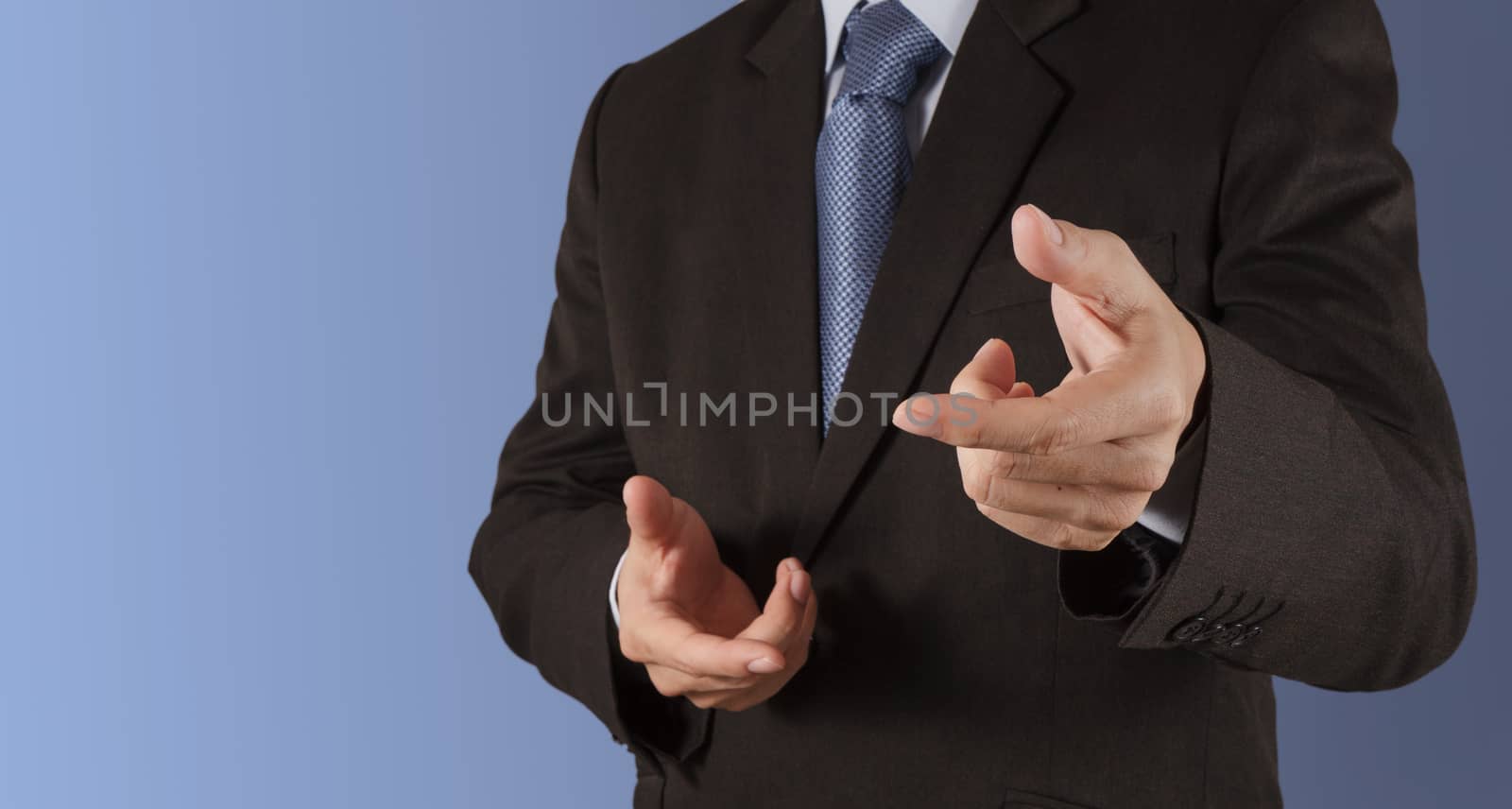 Businessman hand pressing an imaginary button on virtual screen