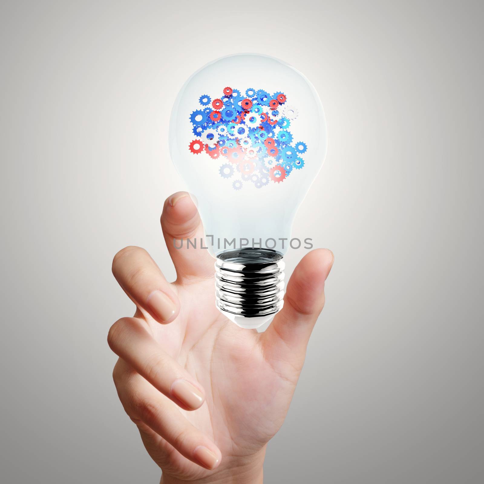 hand showing light bulb with gears as concept  by everythingpossible