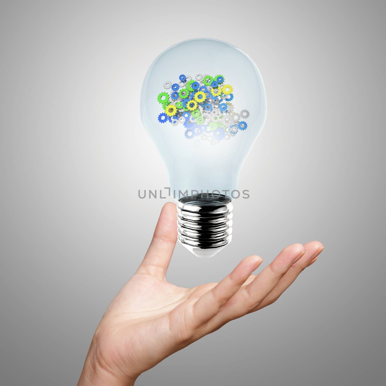 hand showing light bulb with gears as concept by everythingpossible