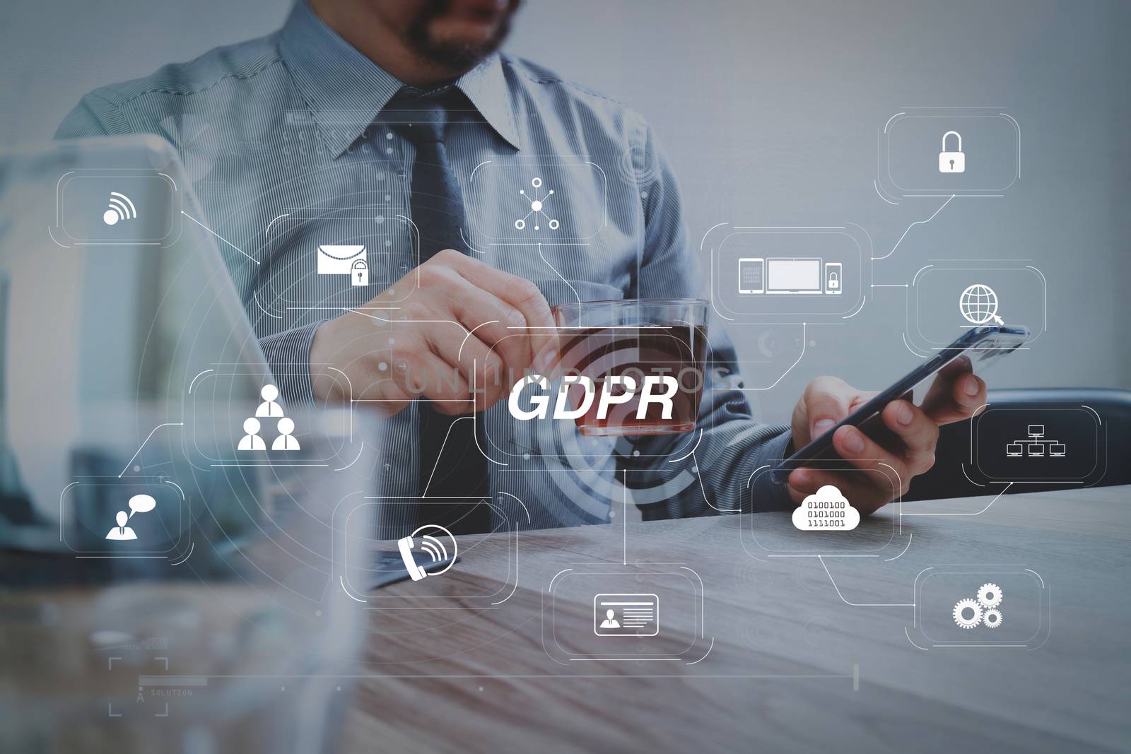 GDPR. Data Protection Regulation with Cyber security and privacy virtual diagram.success businessman hand using smart phone,digital tablet docking smart keyboard,coffee cup on wooden desk.