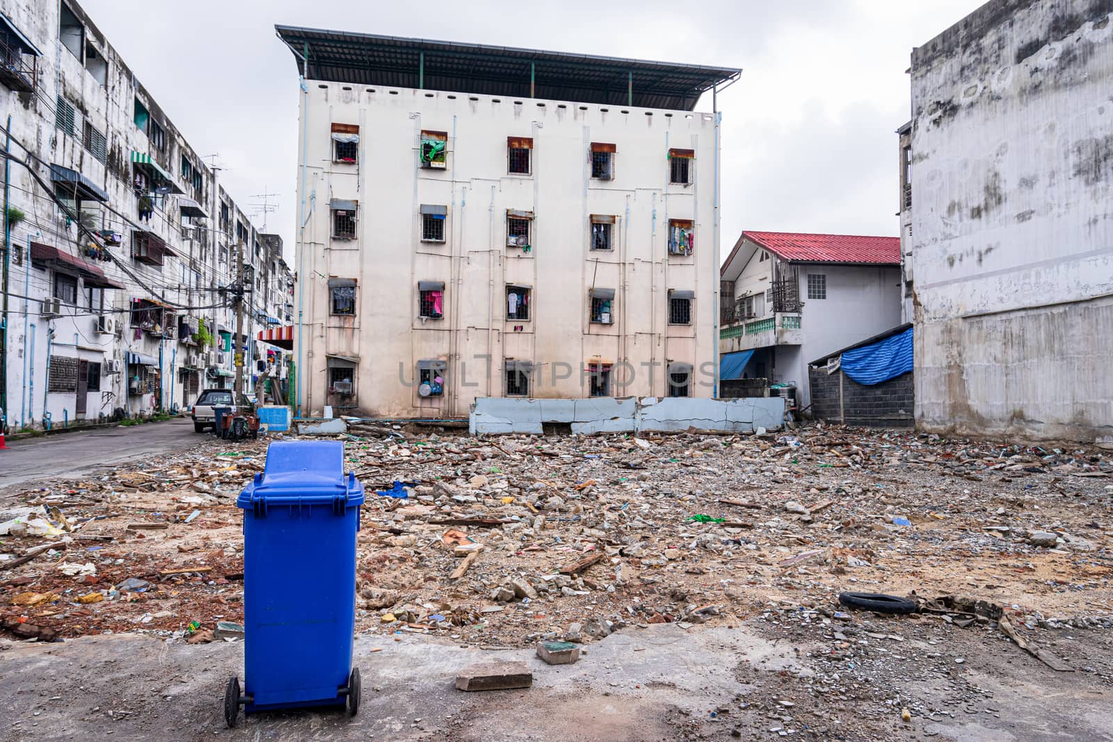 blue trashcan with old building background