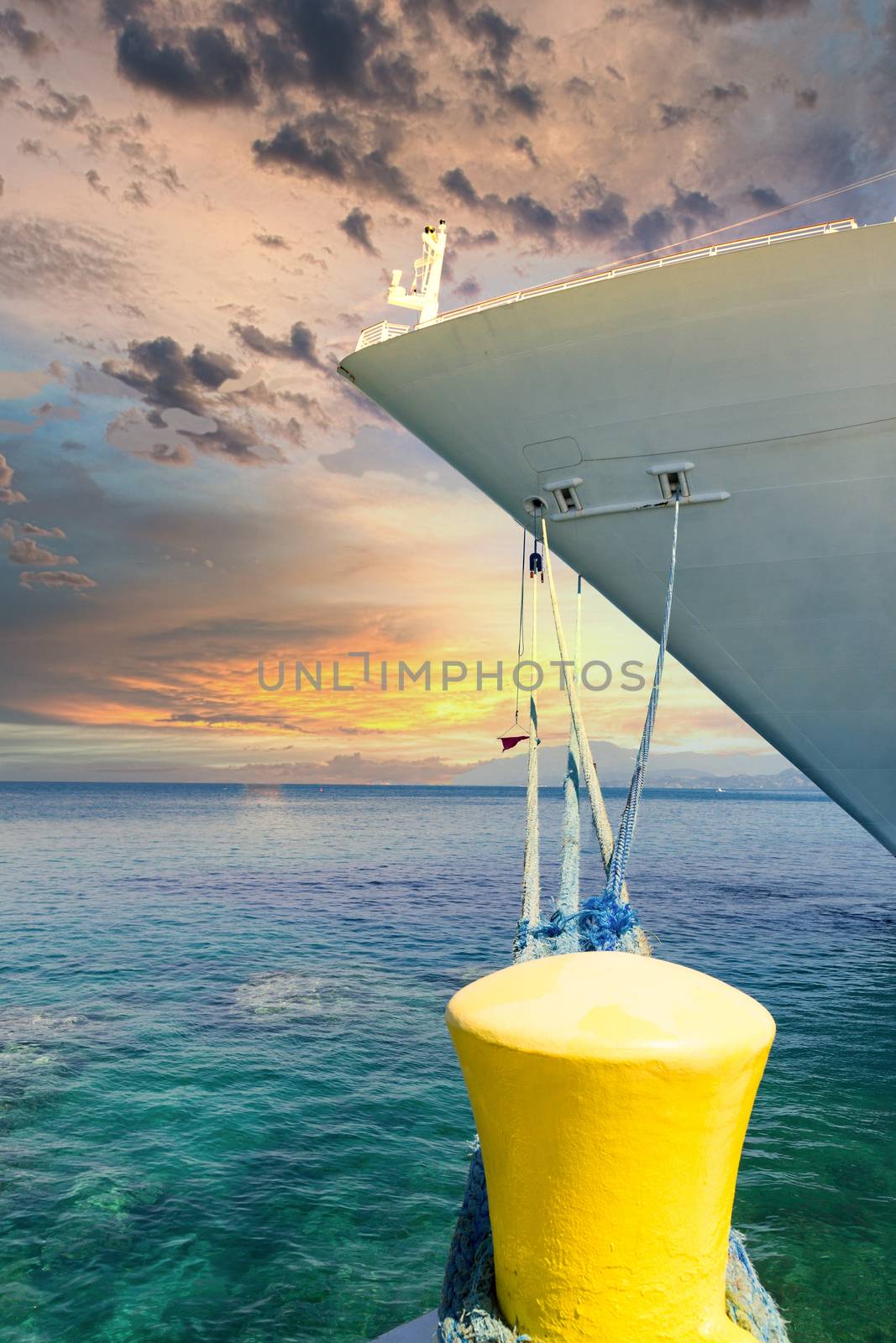 Ship Tied to Yellow Bollard at Sunset by dbvirago