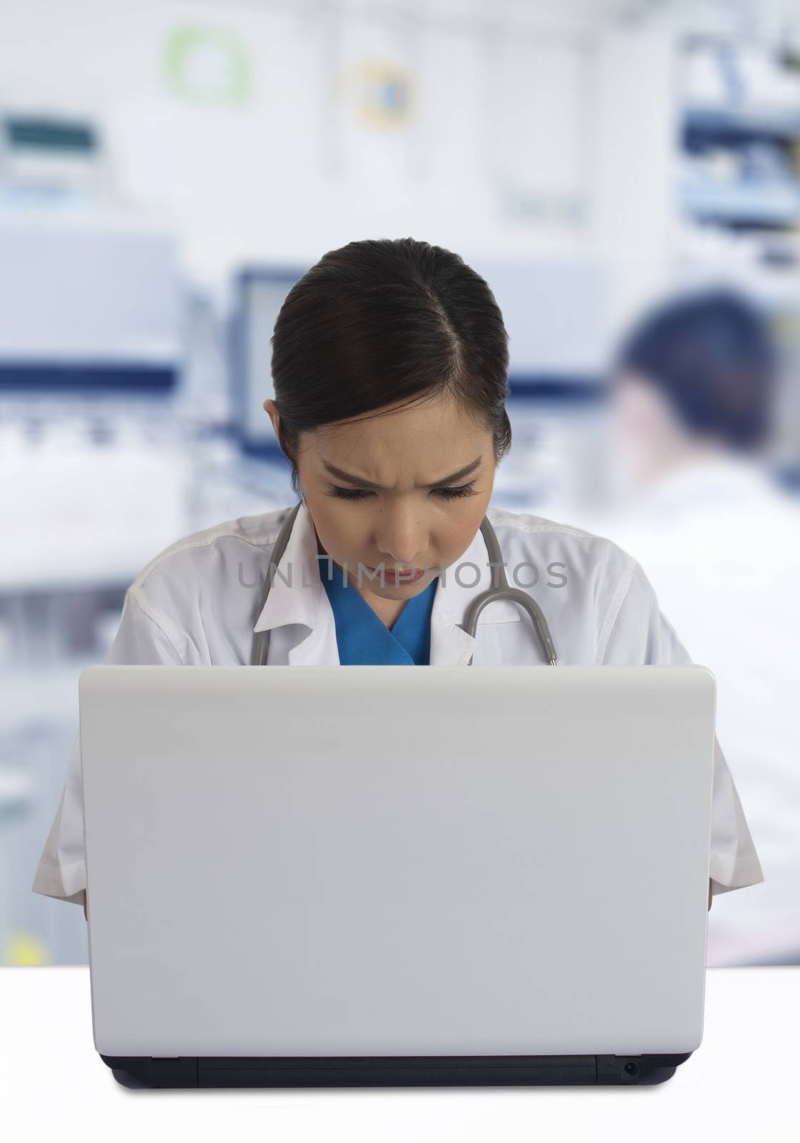 Female doctor working so serious with laptop computer in hospital.