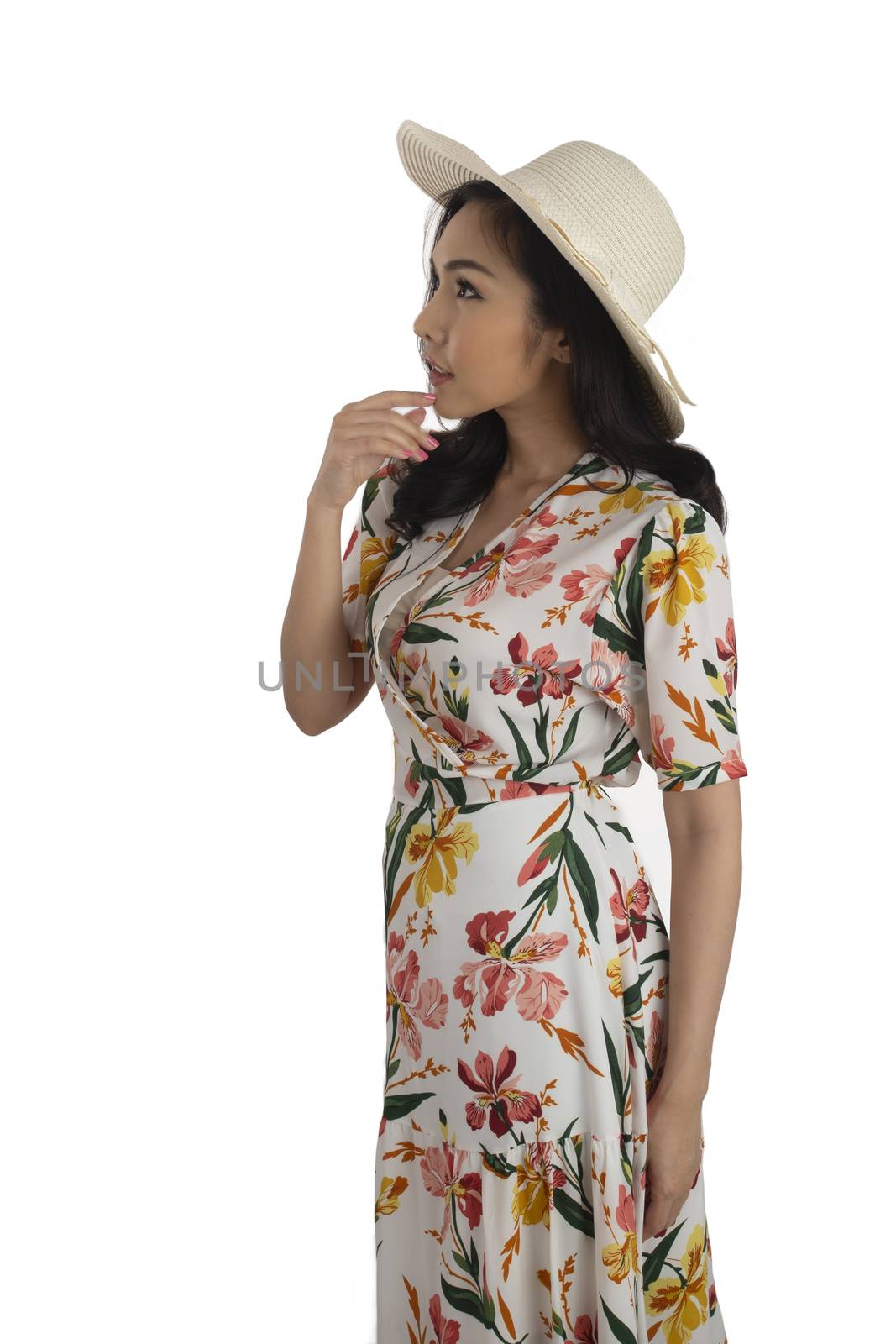 Pretty girl wearing floral dress with white straw hat. by pandpstock_002