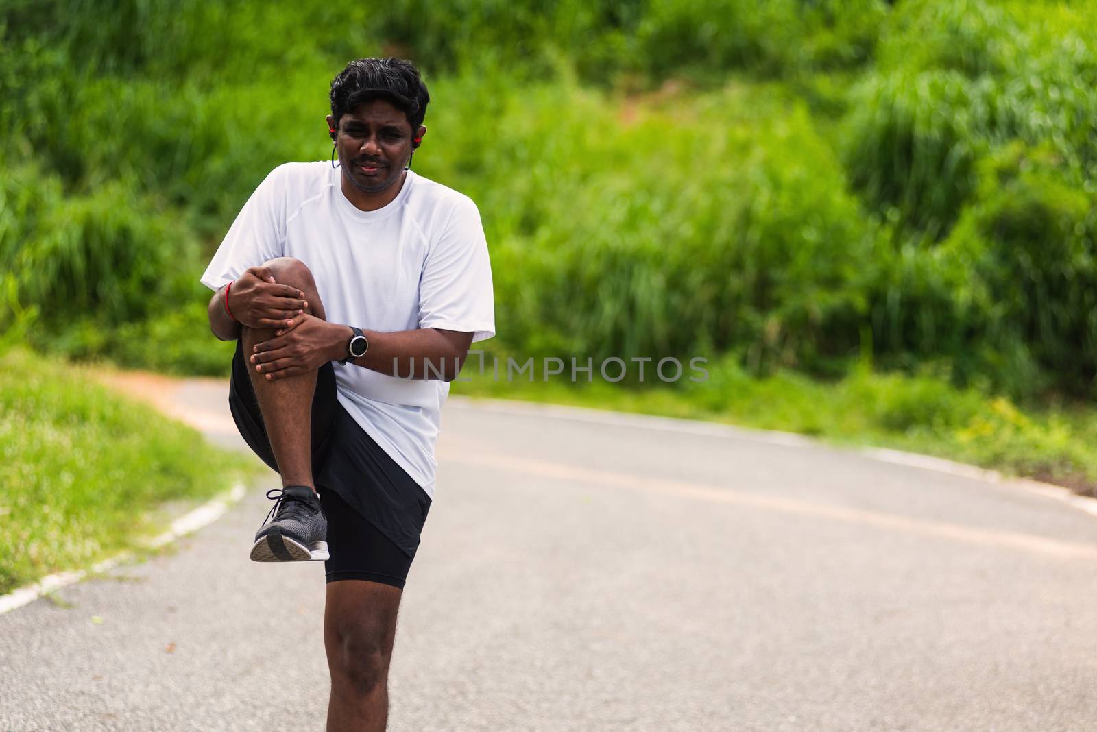 black man standing wear feet shoe warm-up before run by Sorapop