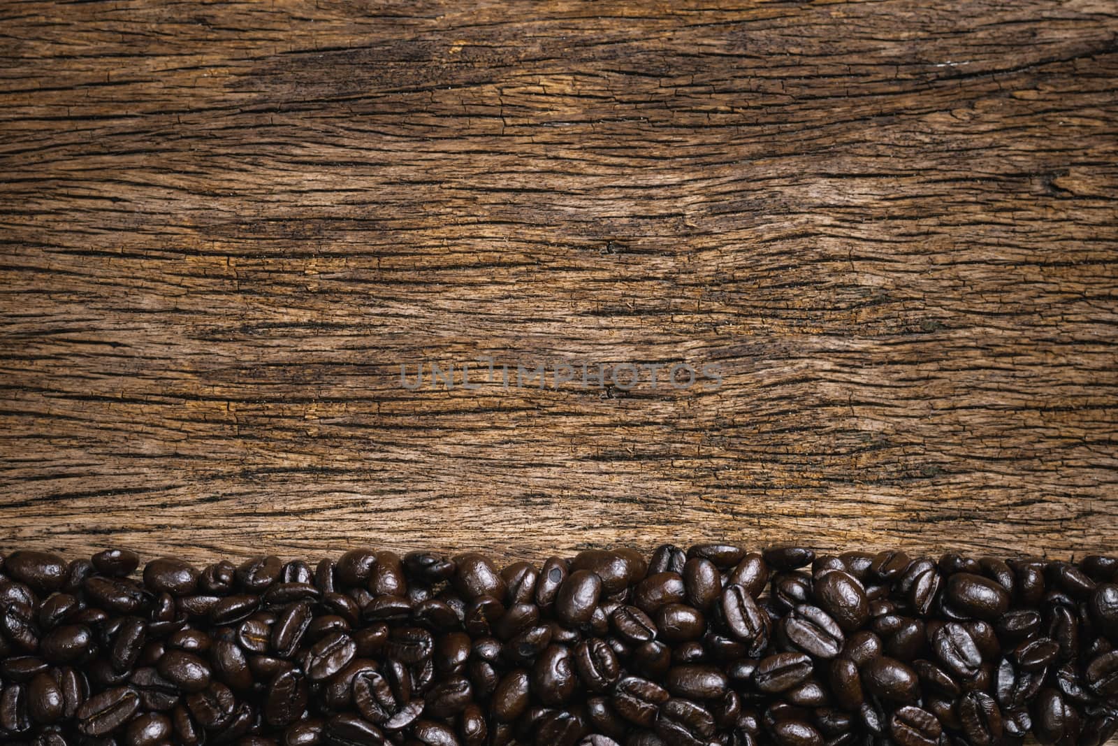 Coffee cup and coffee beans roasted in a sack on a wooden floor.