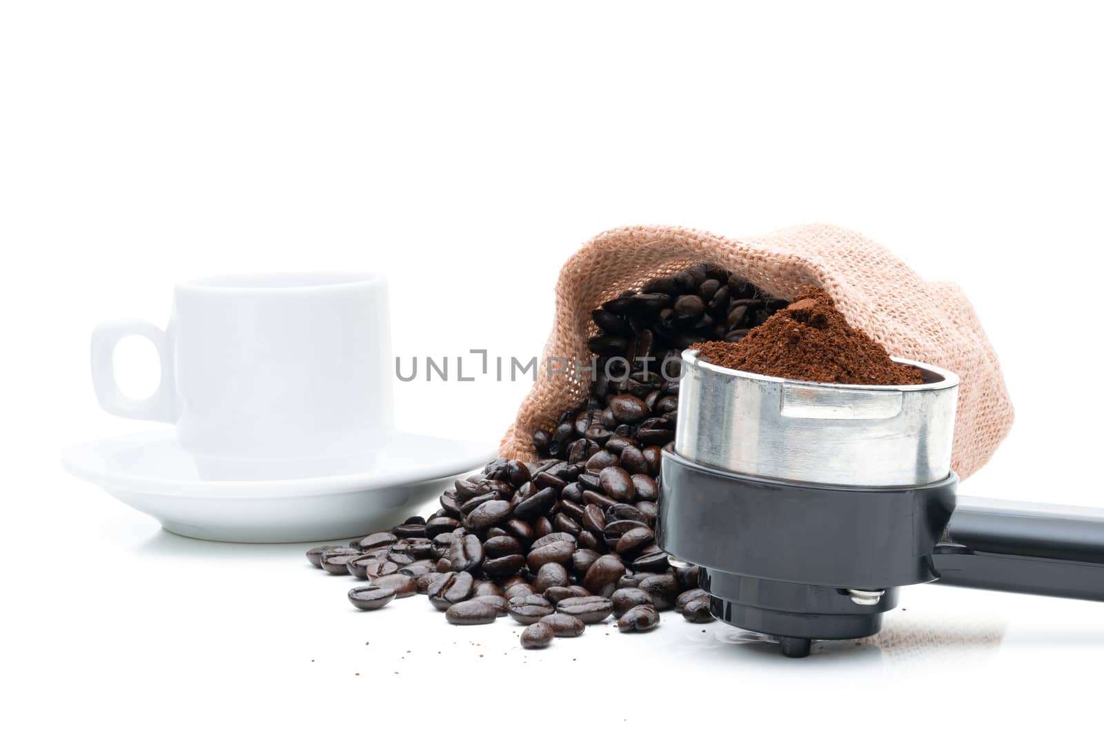 Roasted coffee beans in a sack of cloth on a white background