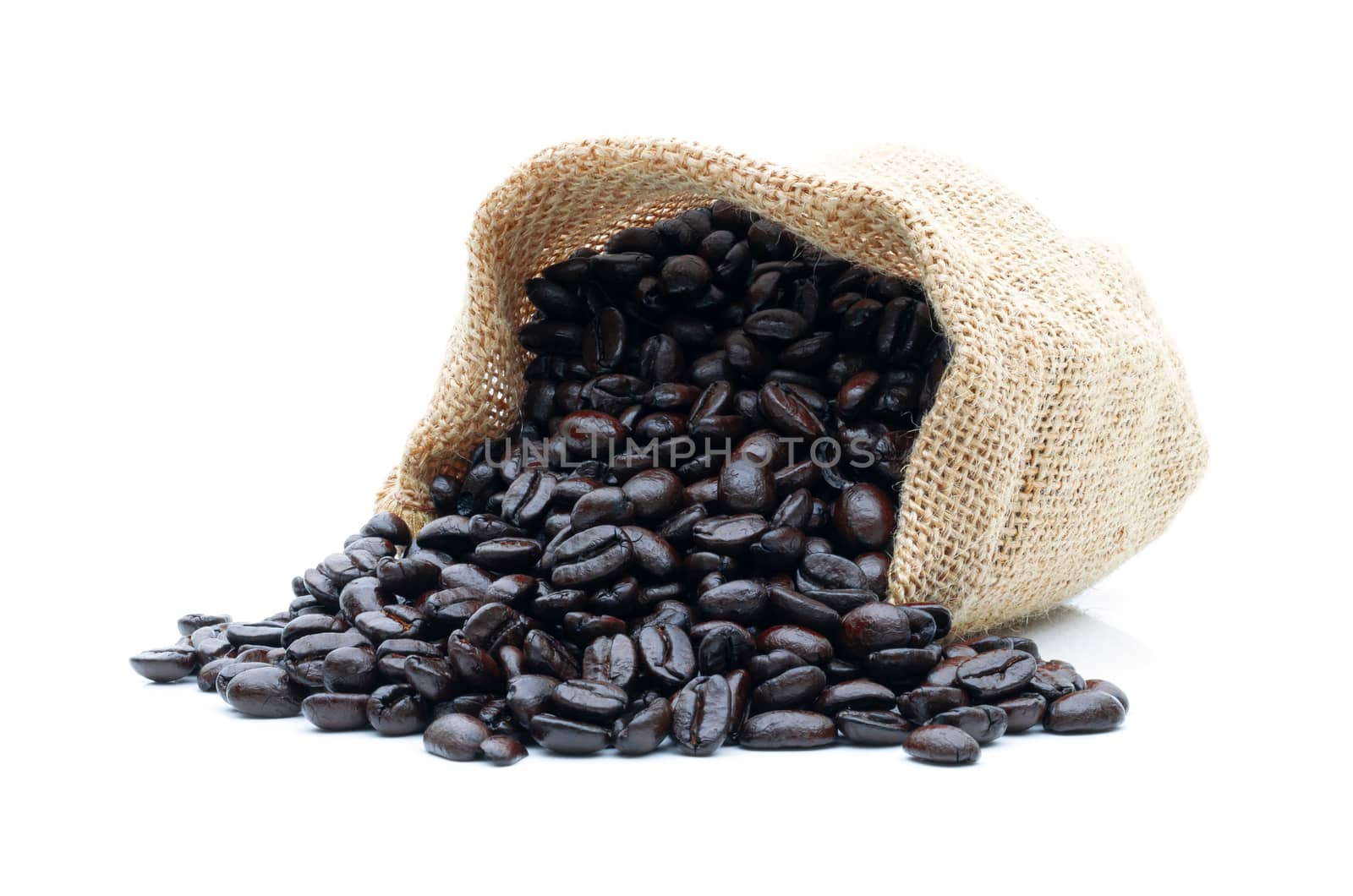 Roasted coffee beans in a sack of cloth on a white background