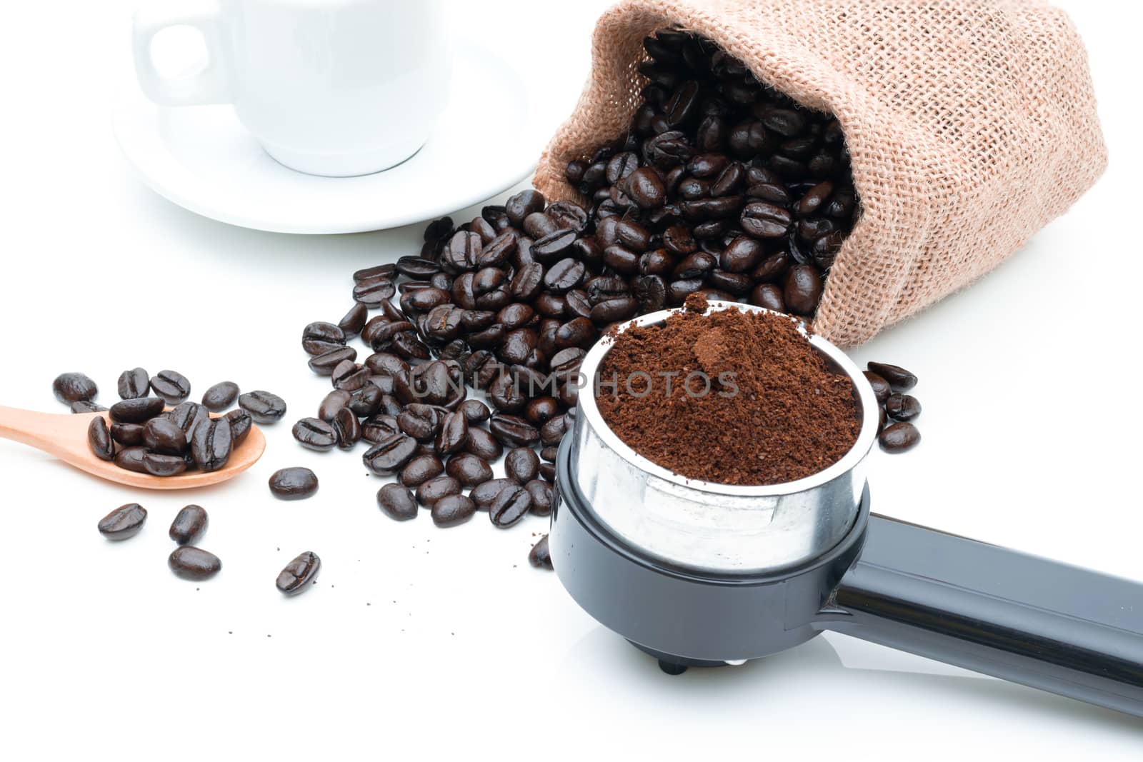 Roasted coffee beans in a sack of cloth on a white background by sompongtom