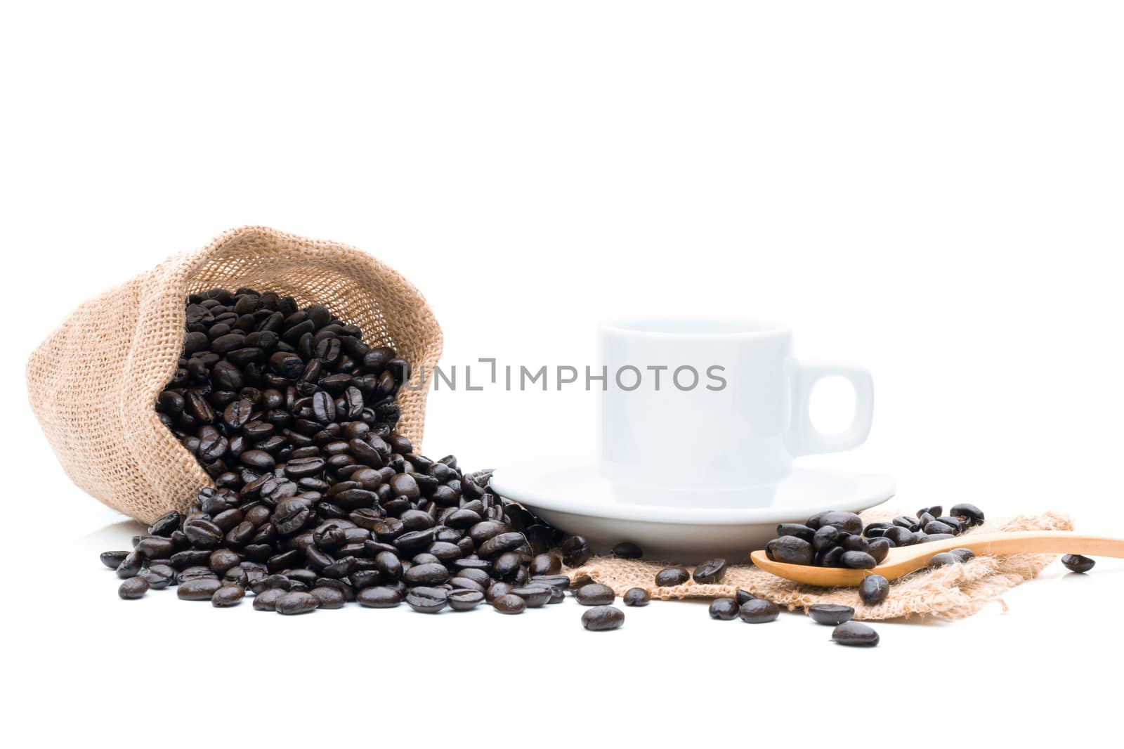 Roasted coffee beans in a sack of cloth on a white background by sompongtom