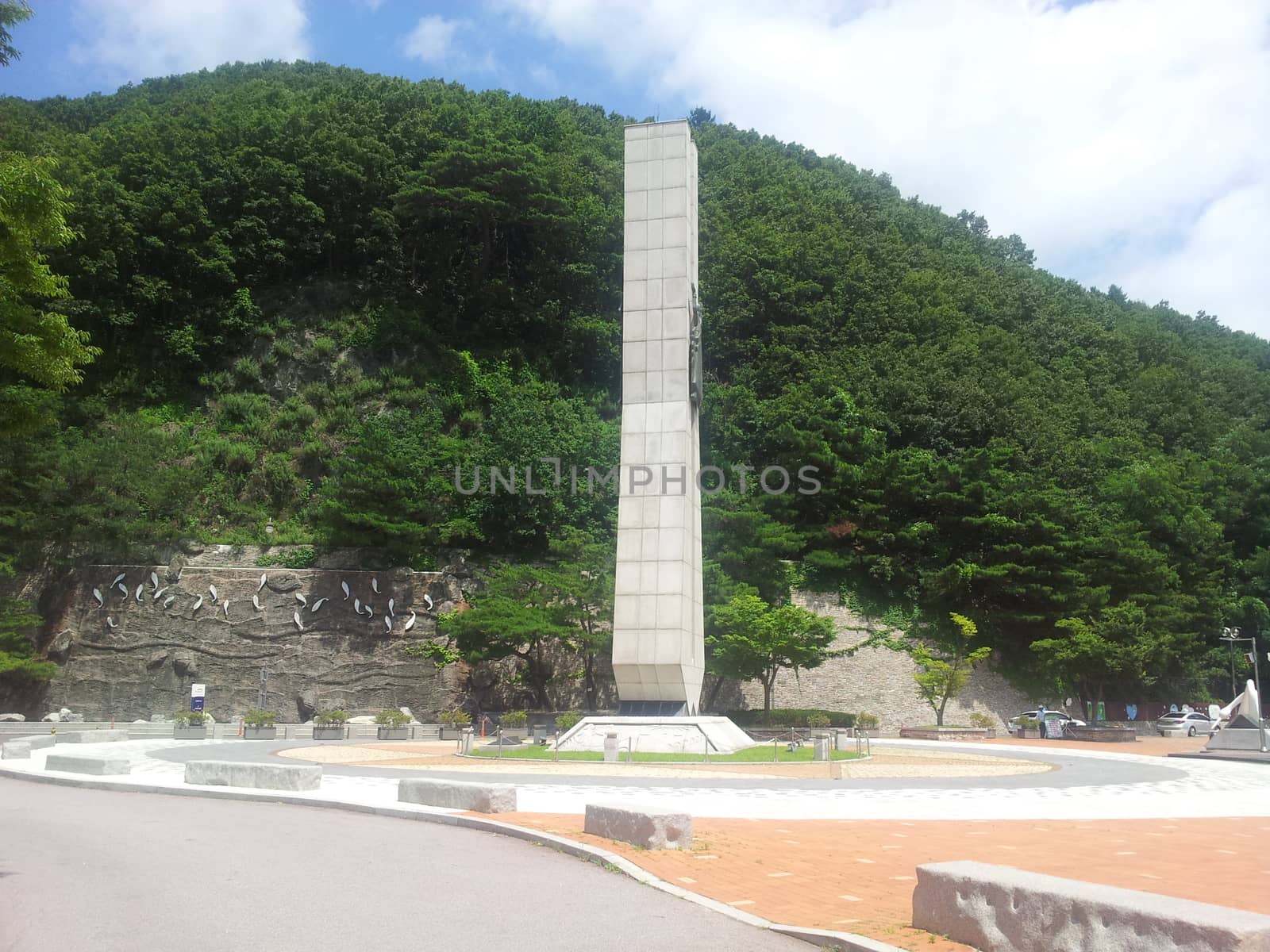 Monument of soyang dame with green mountains and bluse sky in the background. by Photochowk