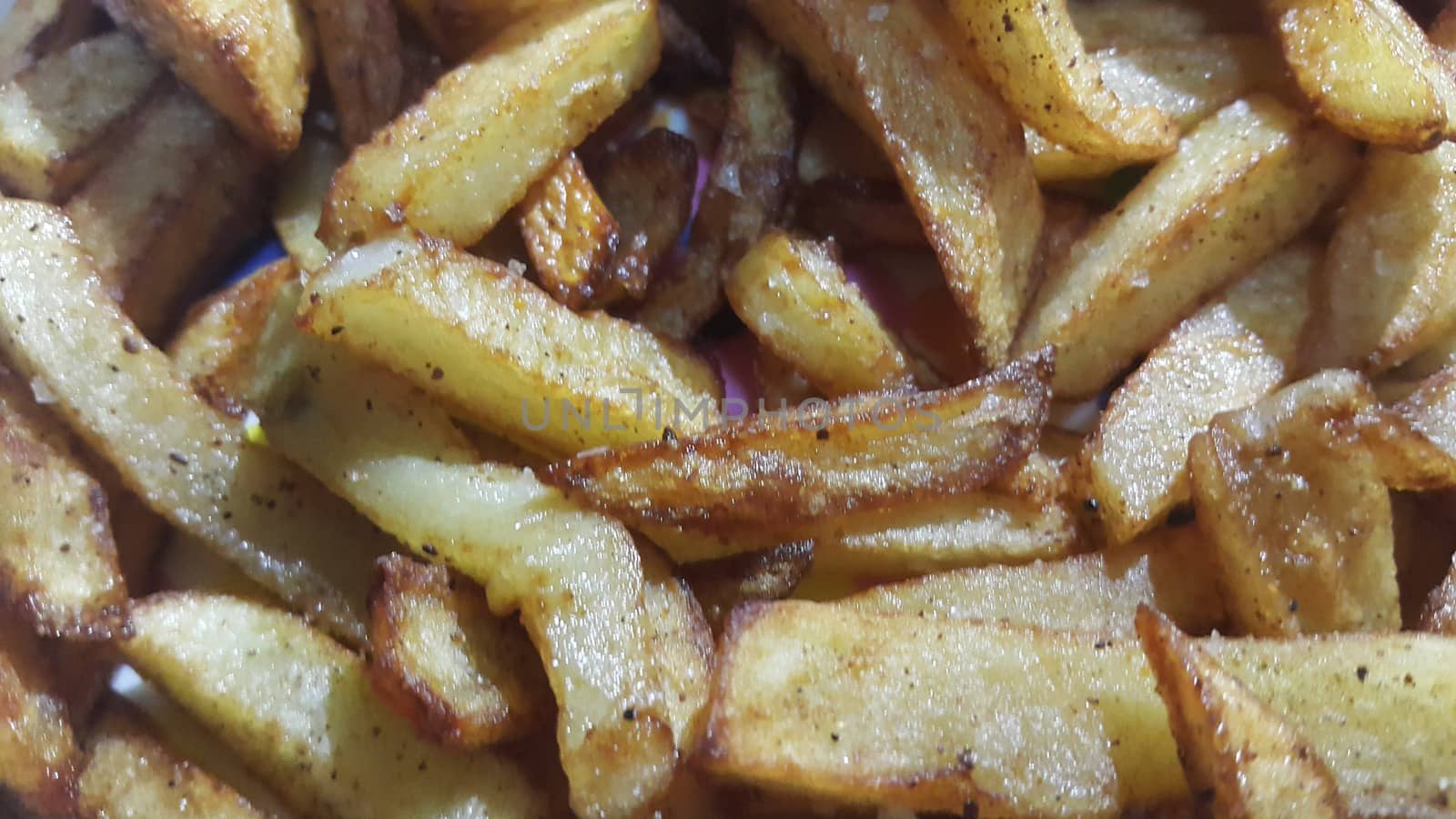 Potato fried or roasted slices on clean background with copy space by Photochowk