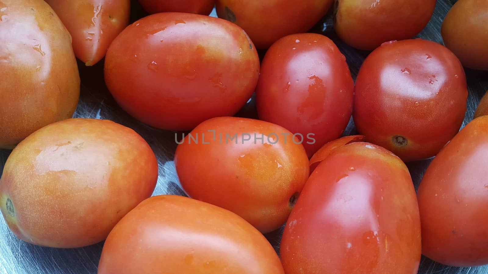 Red tomatoes in super market for sale by Photochowk