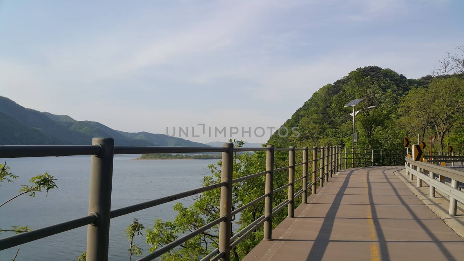 Beautiful view of wooden track for pedestrian exercise and cycling by Photochowk