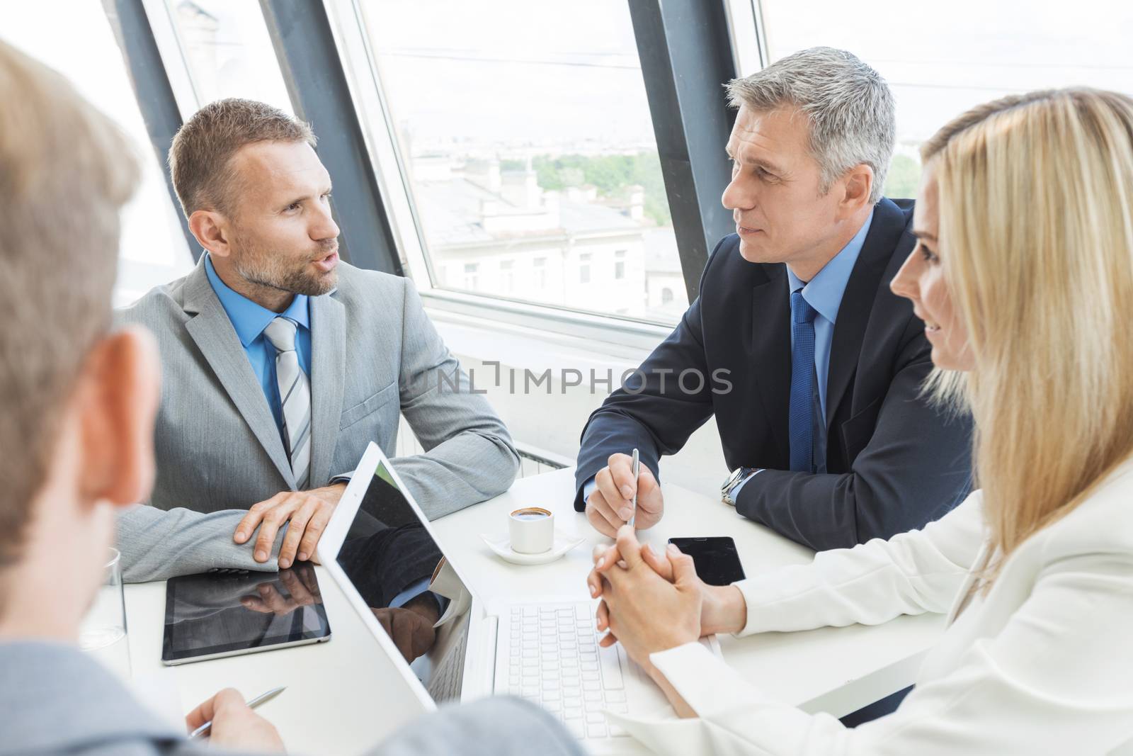 Team of business people talking at meeting in office