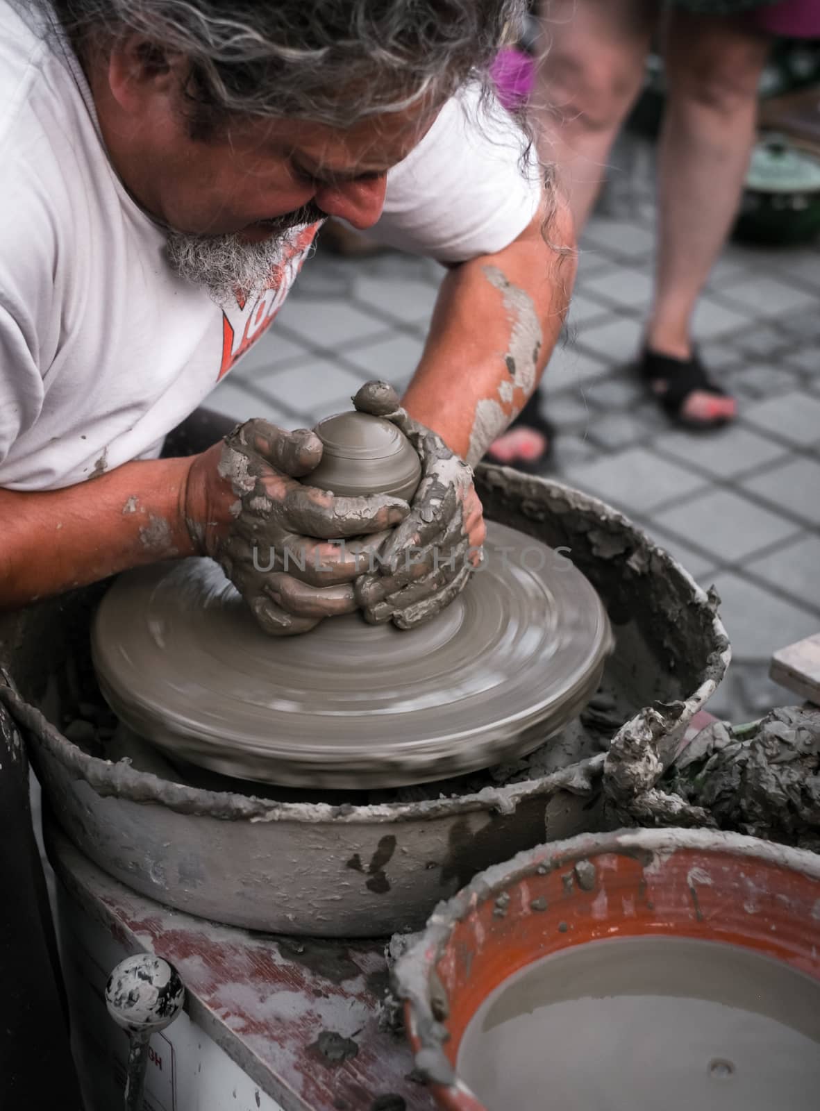 Sibiu City, Romania - 31 August 2019. Hands of a potter shaping a clay pot on a potter's wheel at the potters fair from Sibiu, Romania