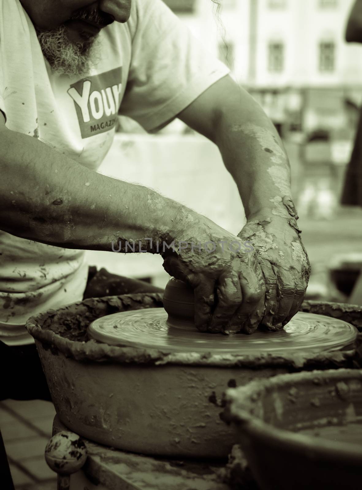 Sibiu City, Romania - 31 August 2019. Hands of a potter shaping a clay pot on a potter's wheel at the potters fair from Sibiu, Romania