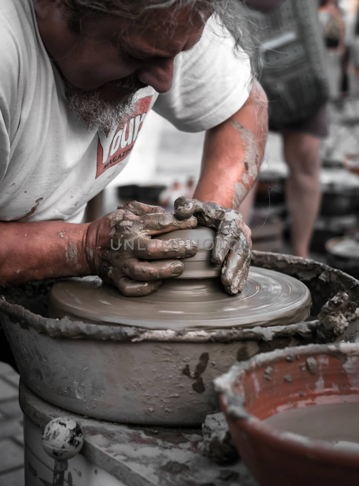 Sibiu City, Romania - 31 August 2019. Hands of a potter shaping a clay pot on a potter's wheel at the potters fair from Sibiu, Romania