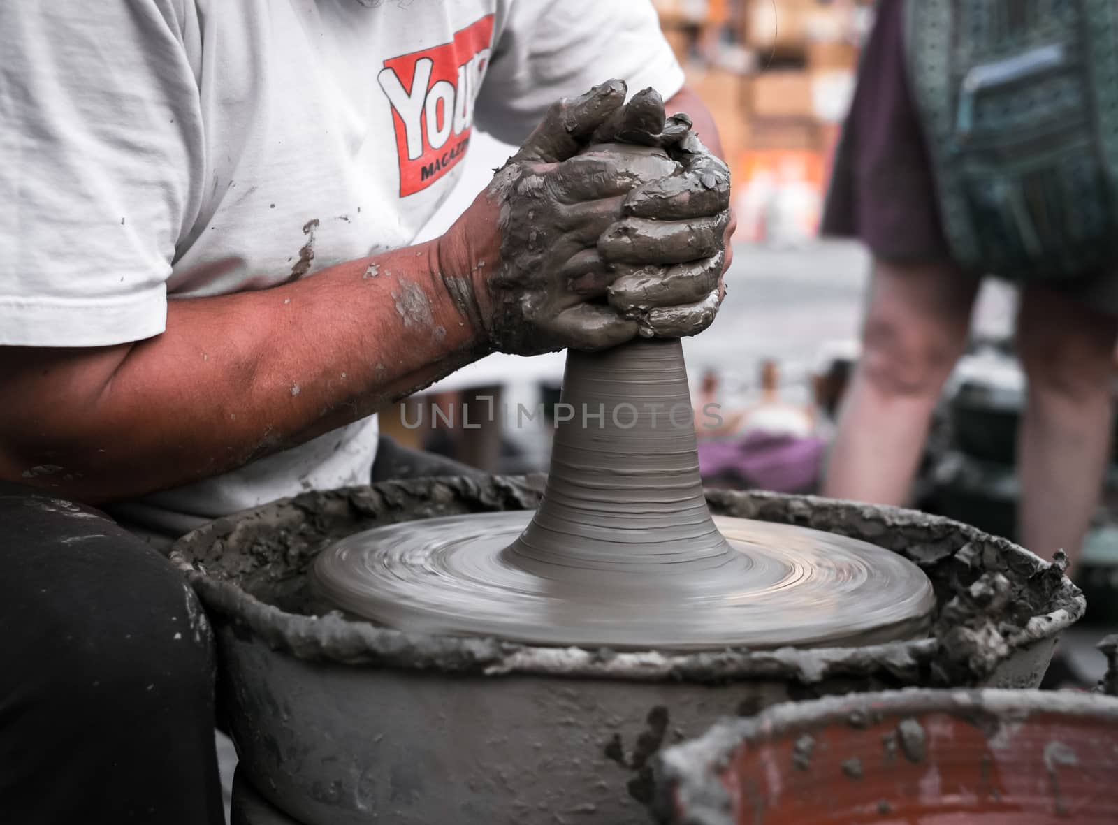 Sibiu City, Romania - 31 August 2019. Hands of a potter shaping a clay pot on a potter's wheel at the potters fair from Sibiu, Romania