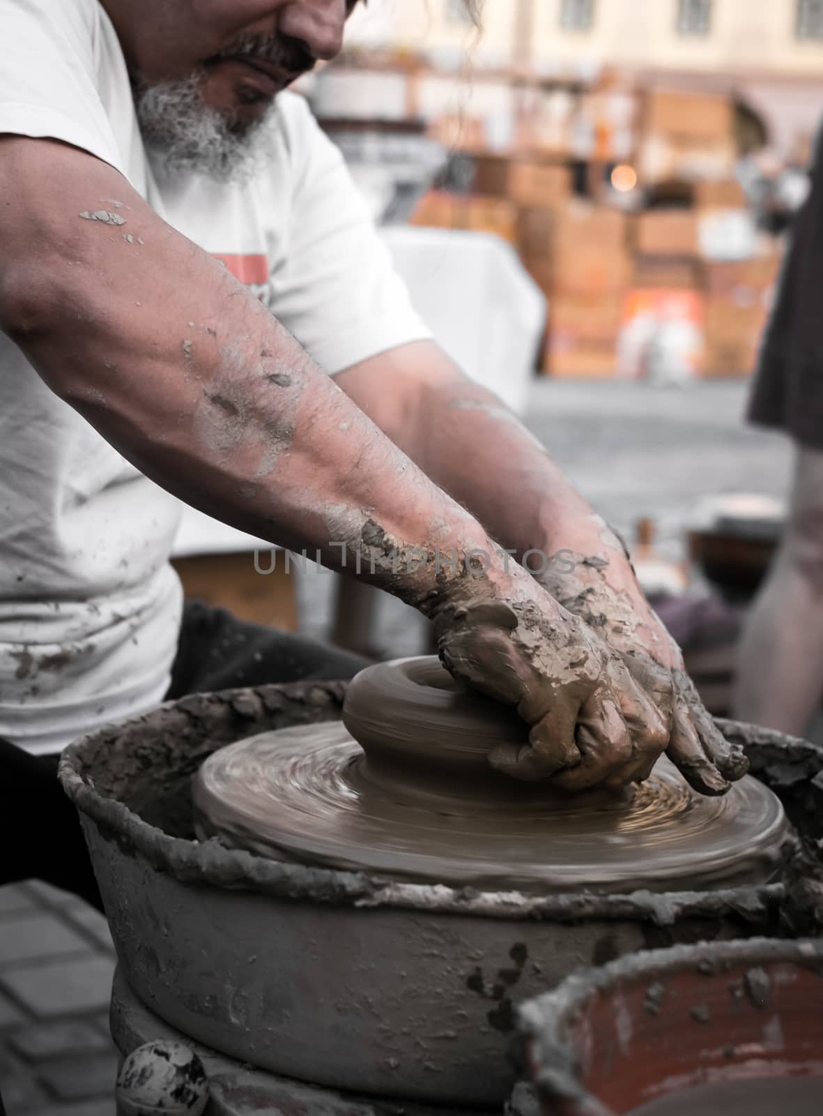 Sibiu City, Romania - 31 August 2019. Hands of a potter shaping a clay pot on a potter's wheel at the potters fair from Sibiu, Romania