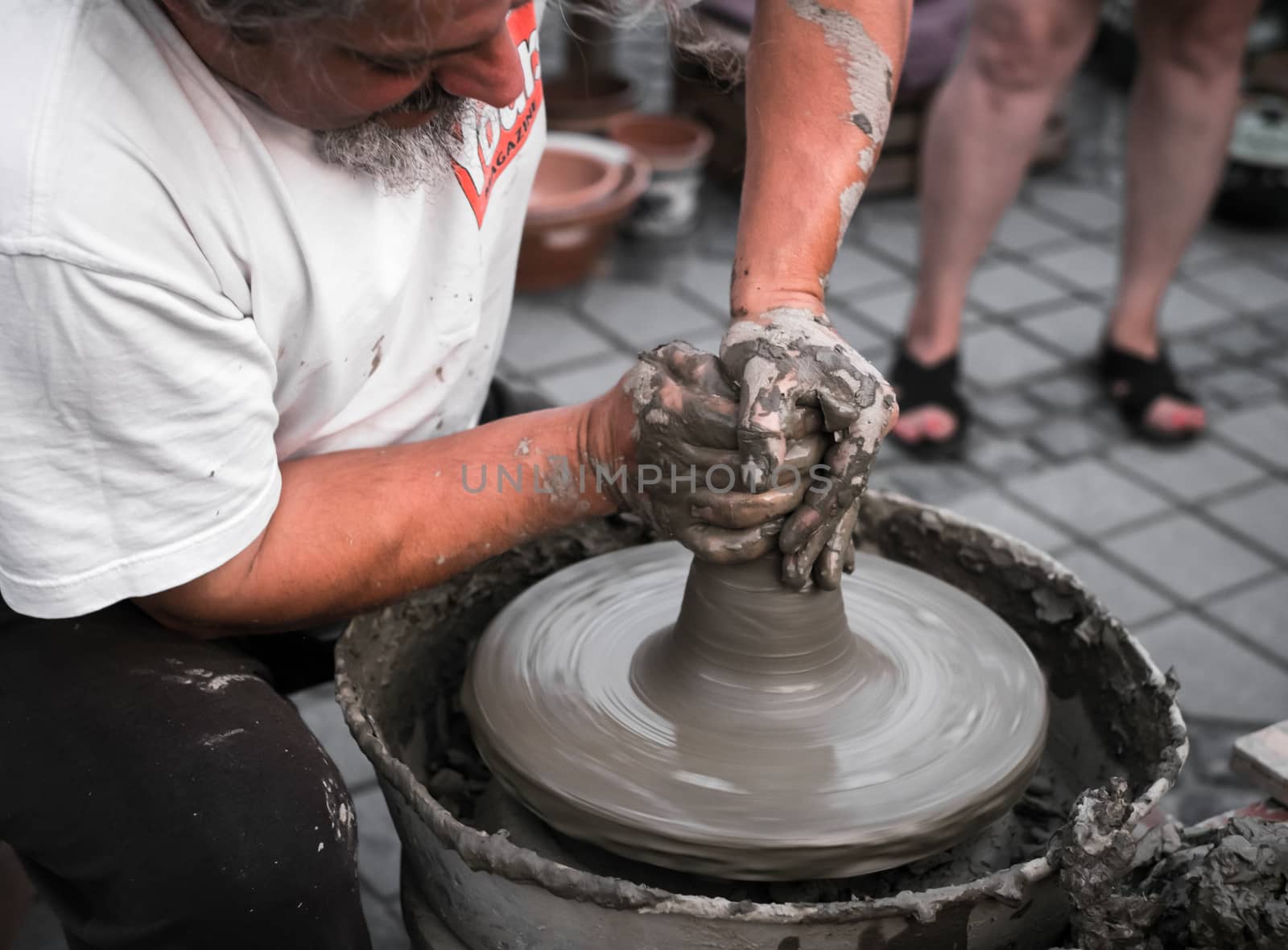 Sibiu City, Romania - 31 August 2019. Hands of a potter shaping a clay pot on a potter's wheel at the potters fair from Sibiu, Romania