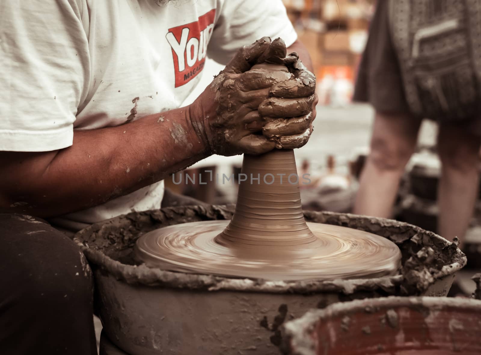 Sibiu City, Romania - 31 August 2019. Hands of a potter shaping a clay pot on a potter's wheel at the potters fair from Sibiu, Romania