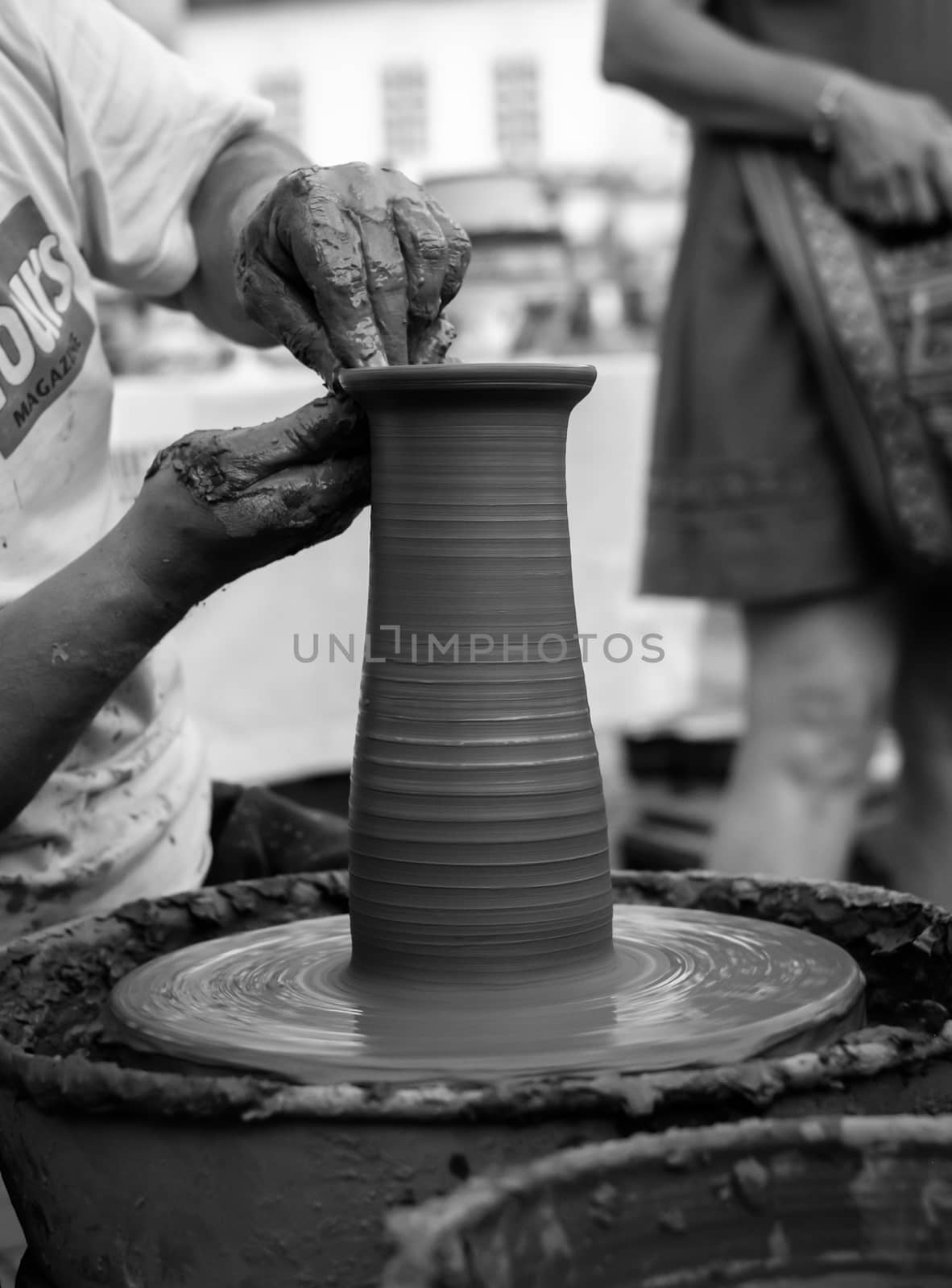 Sibiu City, Romania - 31 August 2019. Hands of a potter shaping a clay pot on a potter's wheel at the potters fair from Sibiu, Romania