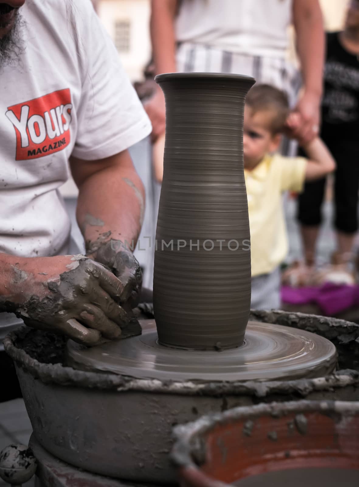 Sibiu City, Romania - 31 August 2019. Hands of a potter shaping a clay pot on a potter's wheel at the potters fair from Sibiu, Romania