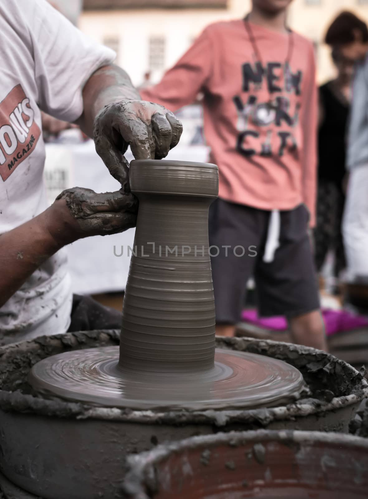 Sibiu City, Romania - 31 August 2019. Hands of a potter shaping a clay pot on a potter's wheel at the potters fair from Sibiu, Romania