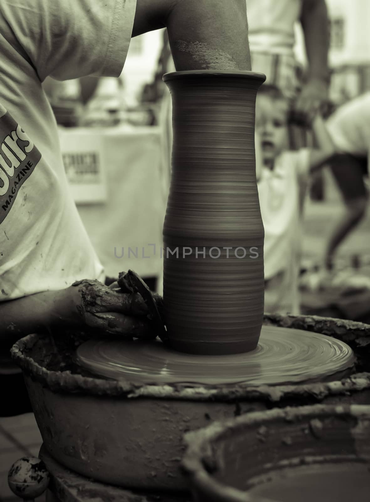 Sibiu City, Romania - 31 August 2019. Hands of a potter shaping a clay pot on a potter's wheel at the potters fair from Sibiu, Romania