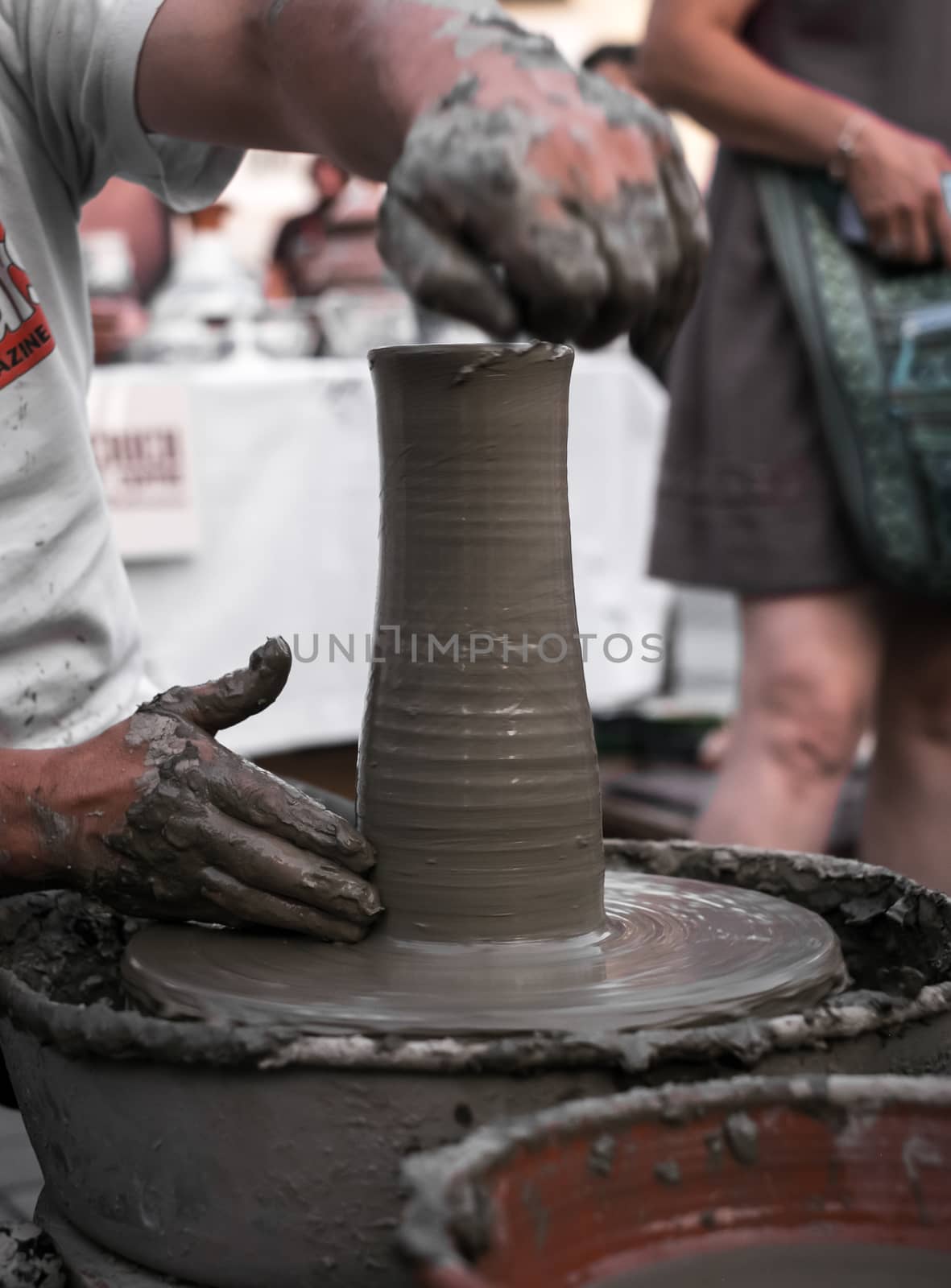 Sibiu City, Romania - 31 August 2019. Hands of a potter shaping a clay pot on a potter's wheel at the potters fair from Sibiu, Romania