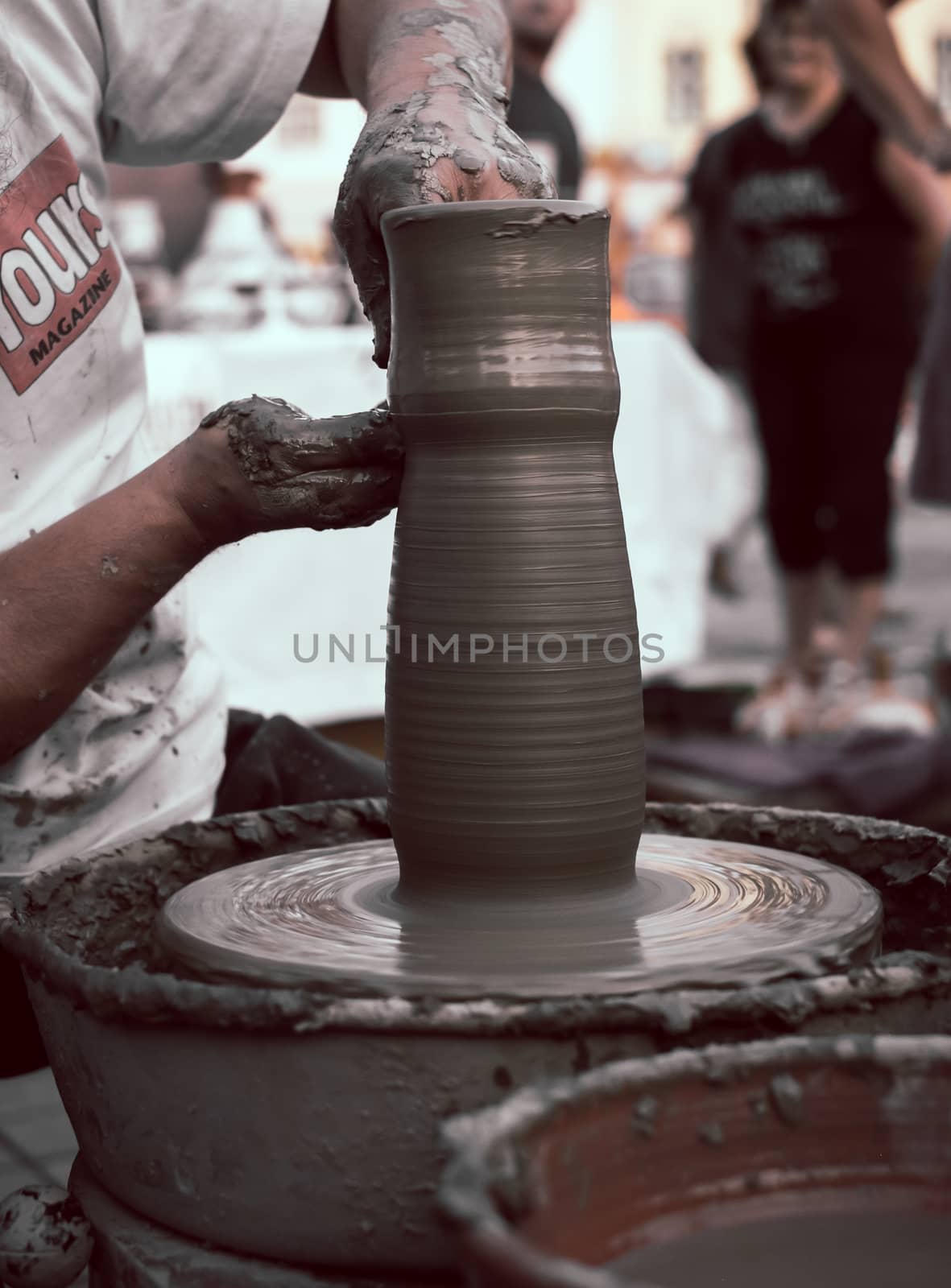 Sibiu City, Romania - 31 August 2019. Hands of a potter shaping a clay pot on a potter's wheel at the potters fair from Sibiu, Romania