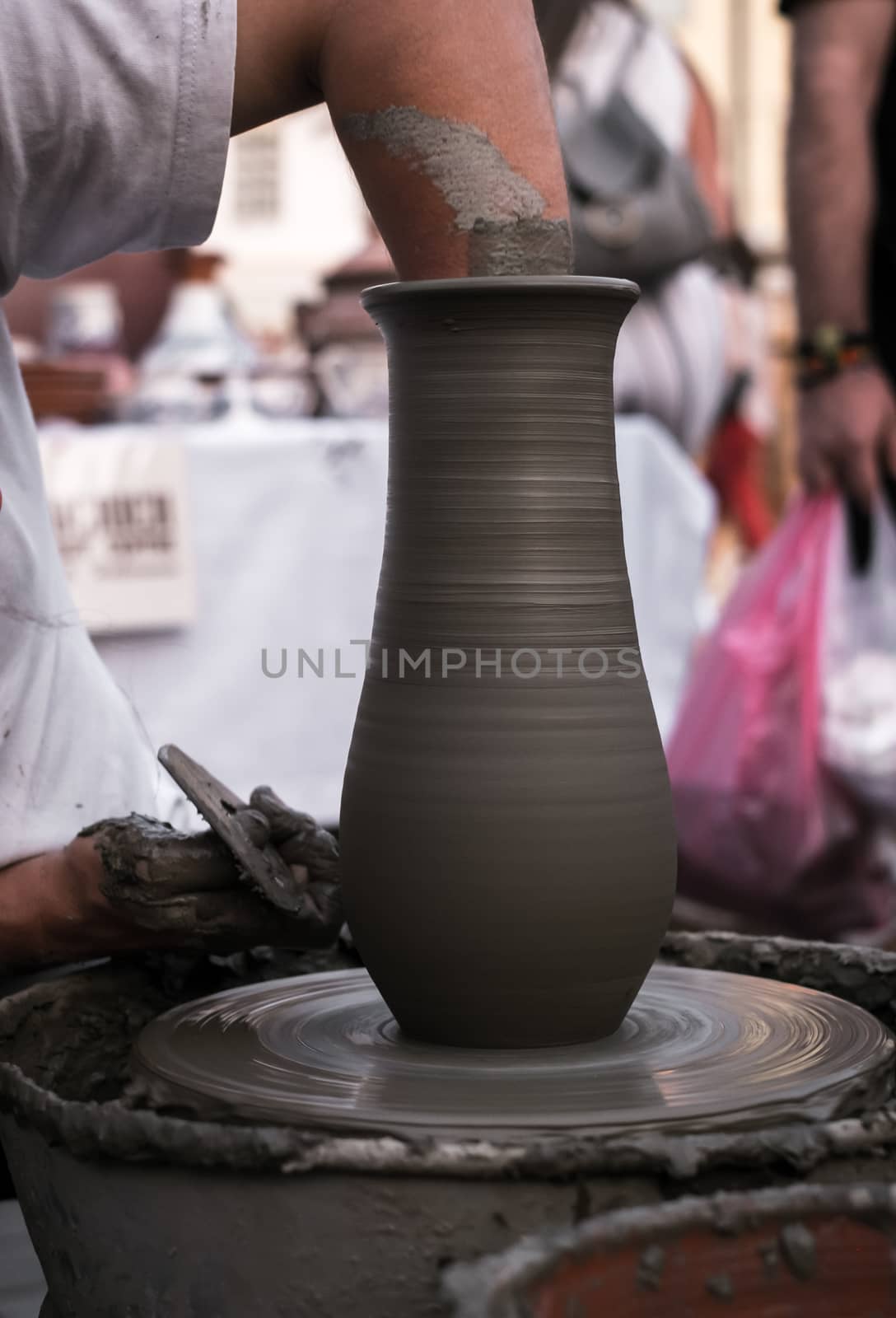 Sibiu City, Romania - 31 August 2019. Hands of a potter shaping a clay pot on a potter's wheel at the potters fair from Sibiu, Romania