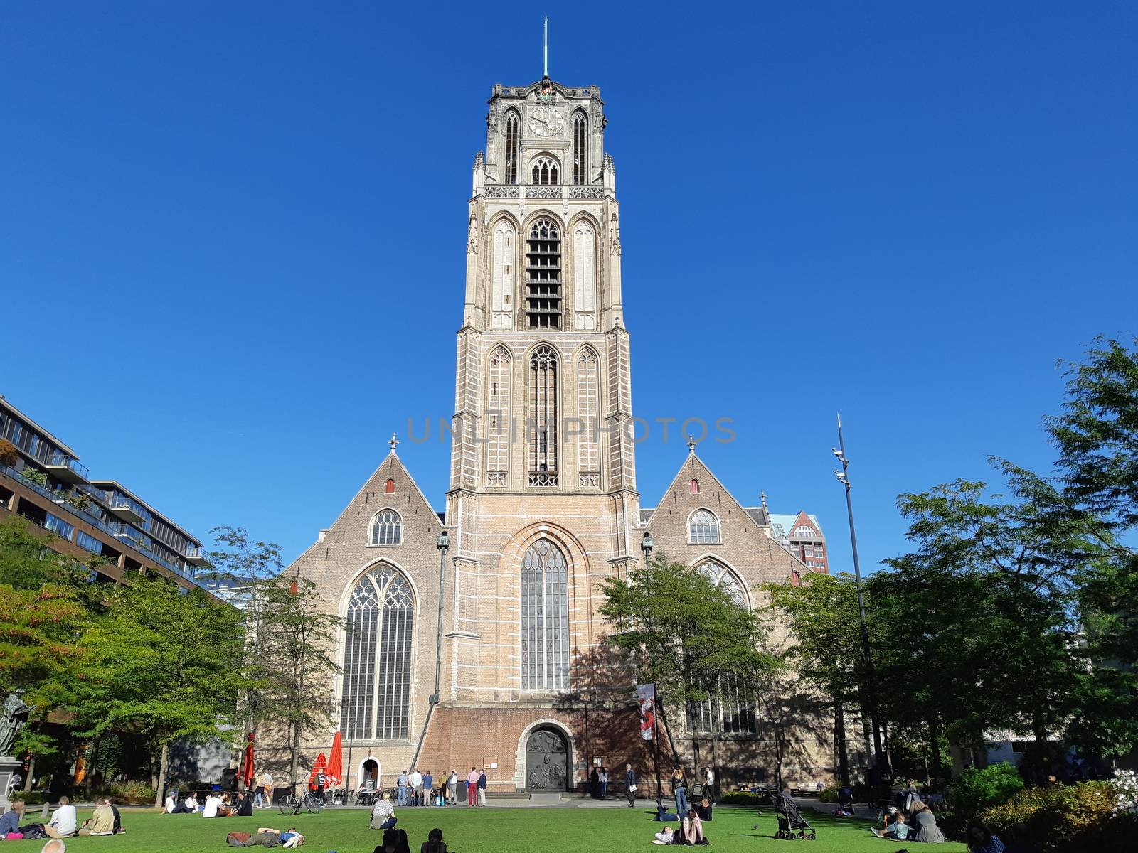 View on the Laurenskerk (Laurens Church) with people enjoying the sun on the Grotekerkplein