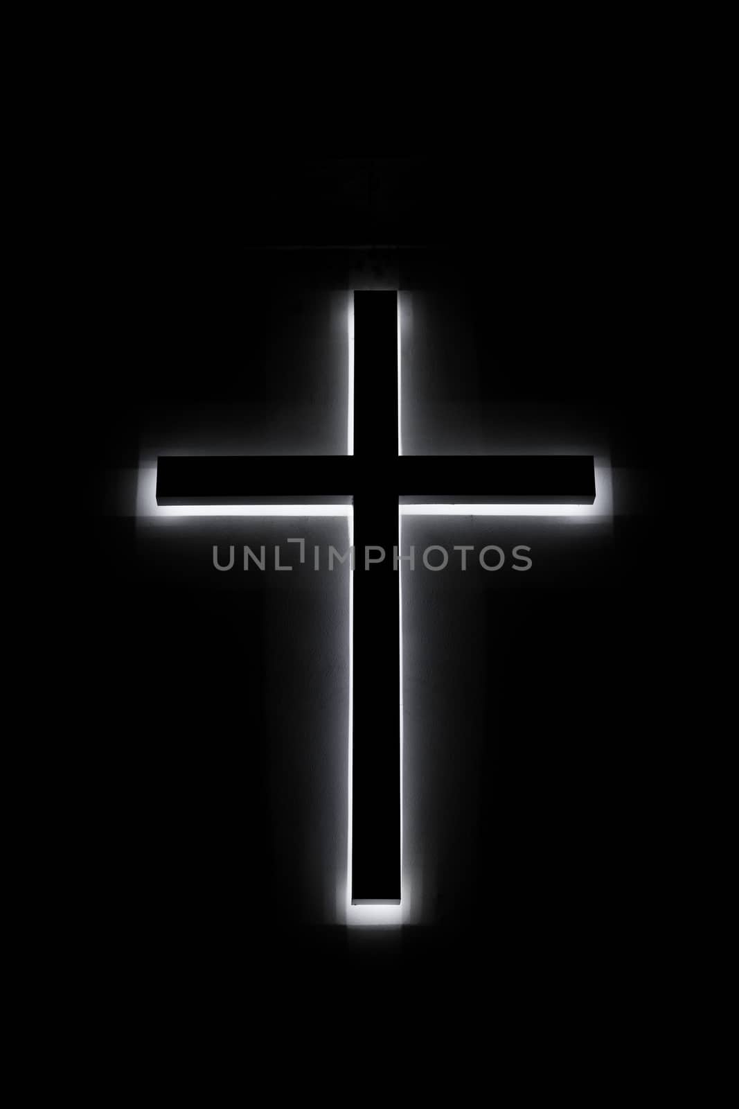 A led glowing church cross light in night