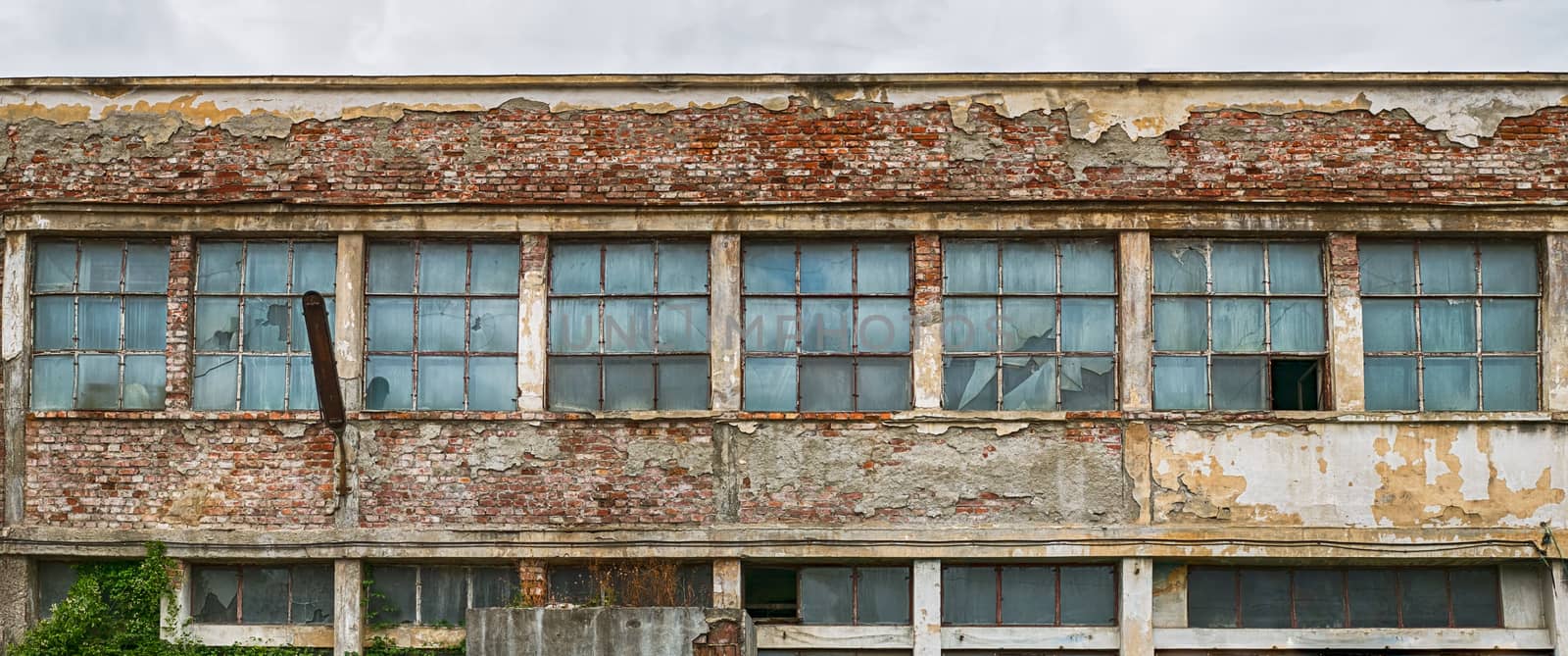 abandoned factory warehouse with broken windows