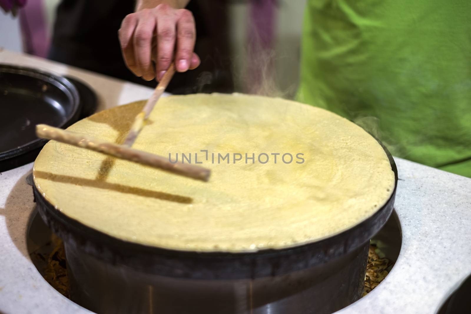 A person making pancakes in a kitchen