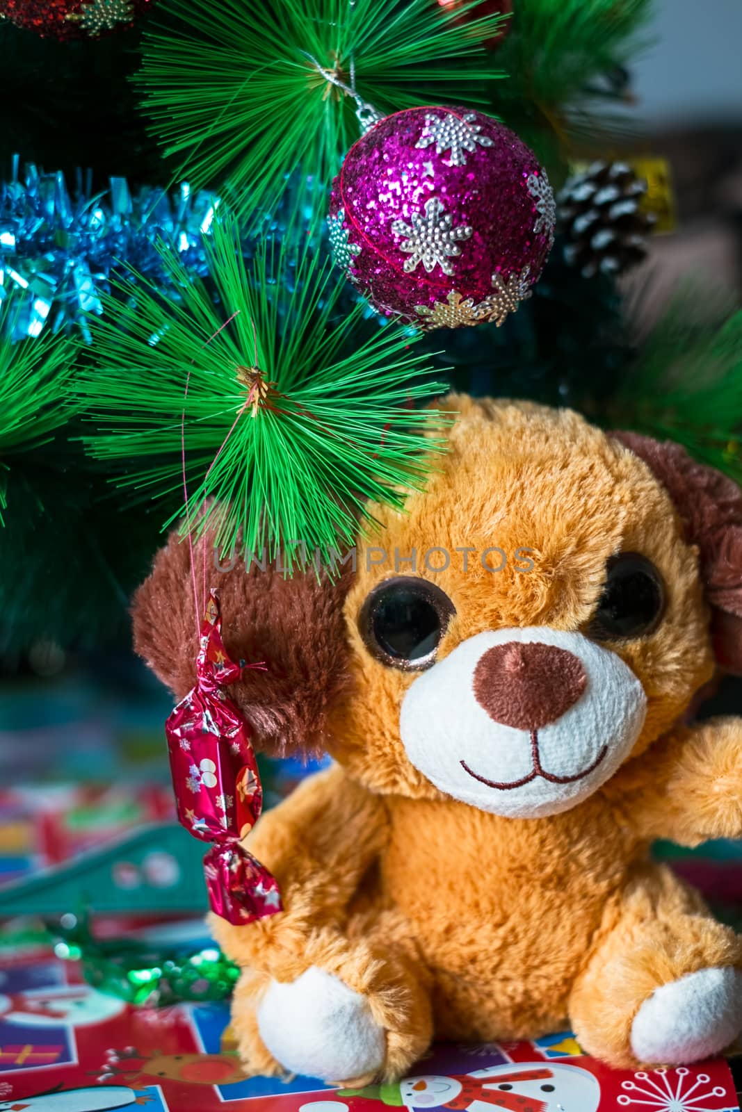 a plush puppy under the christmas tree