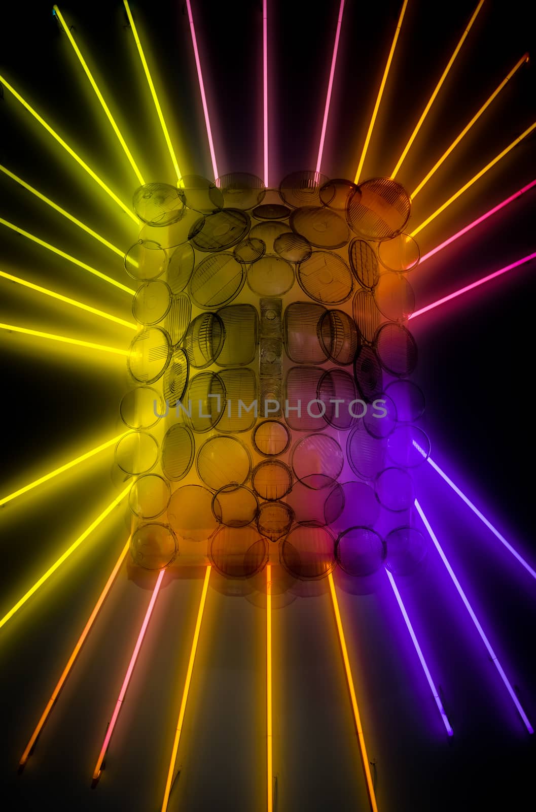 abstract neon lights and car headlights on wall