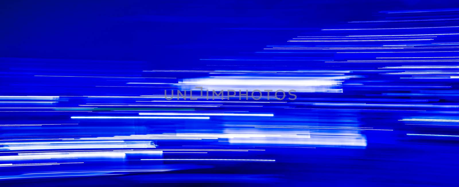 Abstract blue light trails on blue background by Roberto