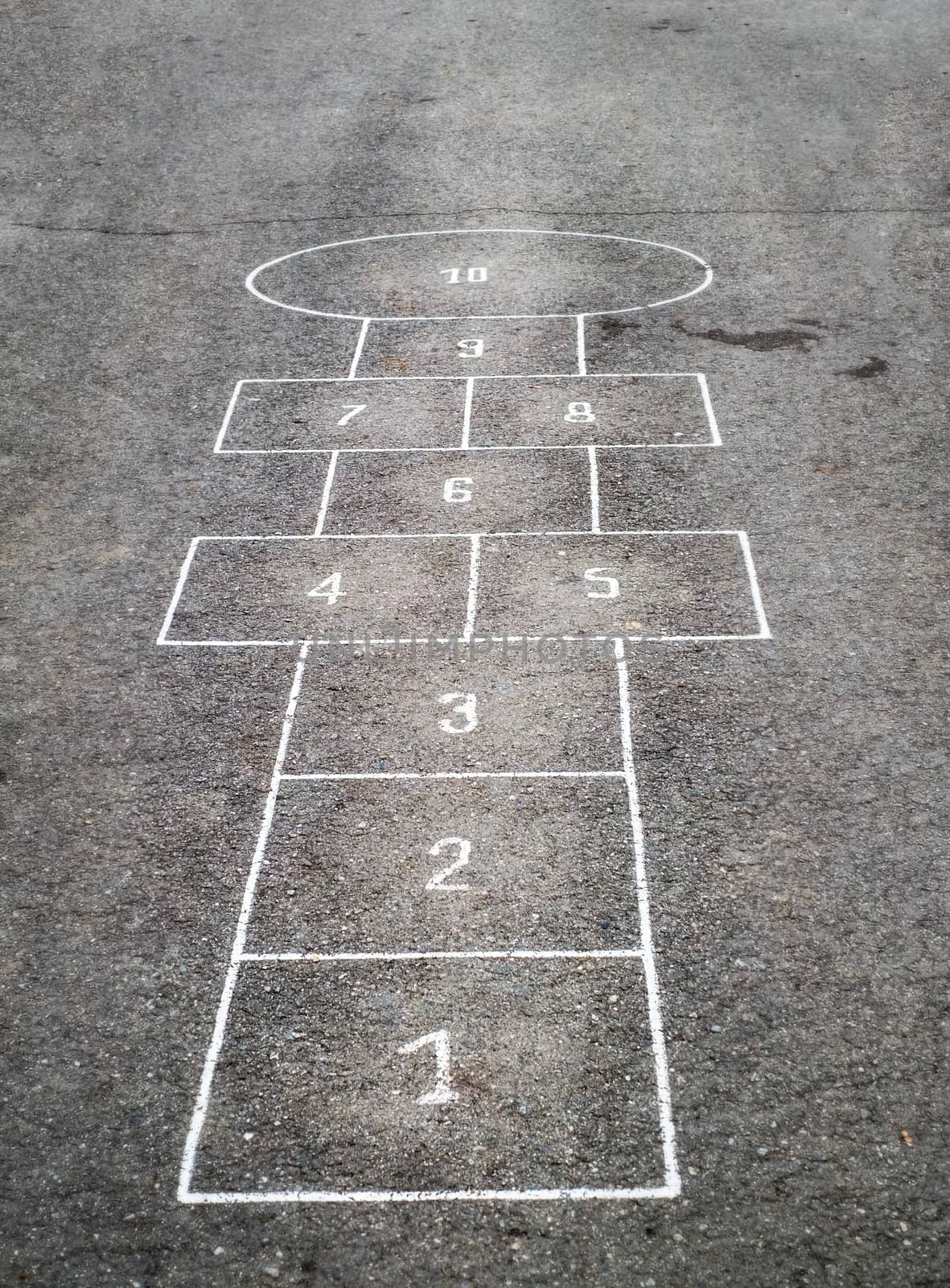 Children's Hopscotch Game on Asphalt City Sidewalk