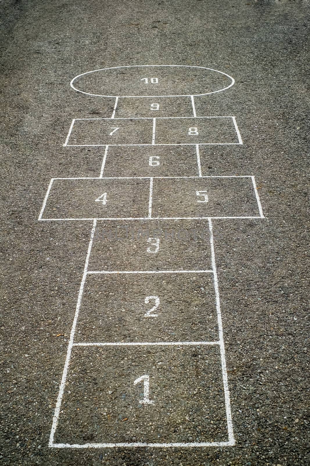 Children's Hopscotch Game on Asphalt City Sidewalk