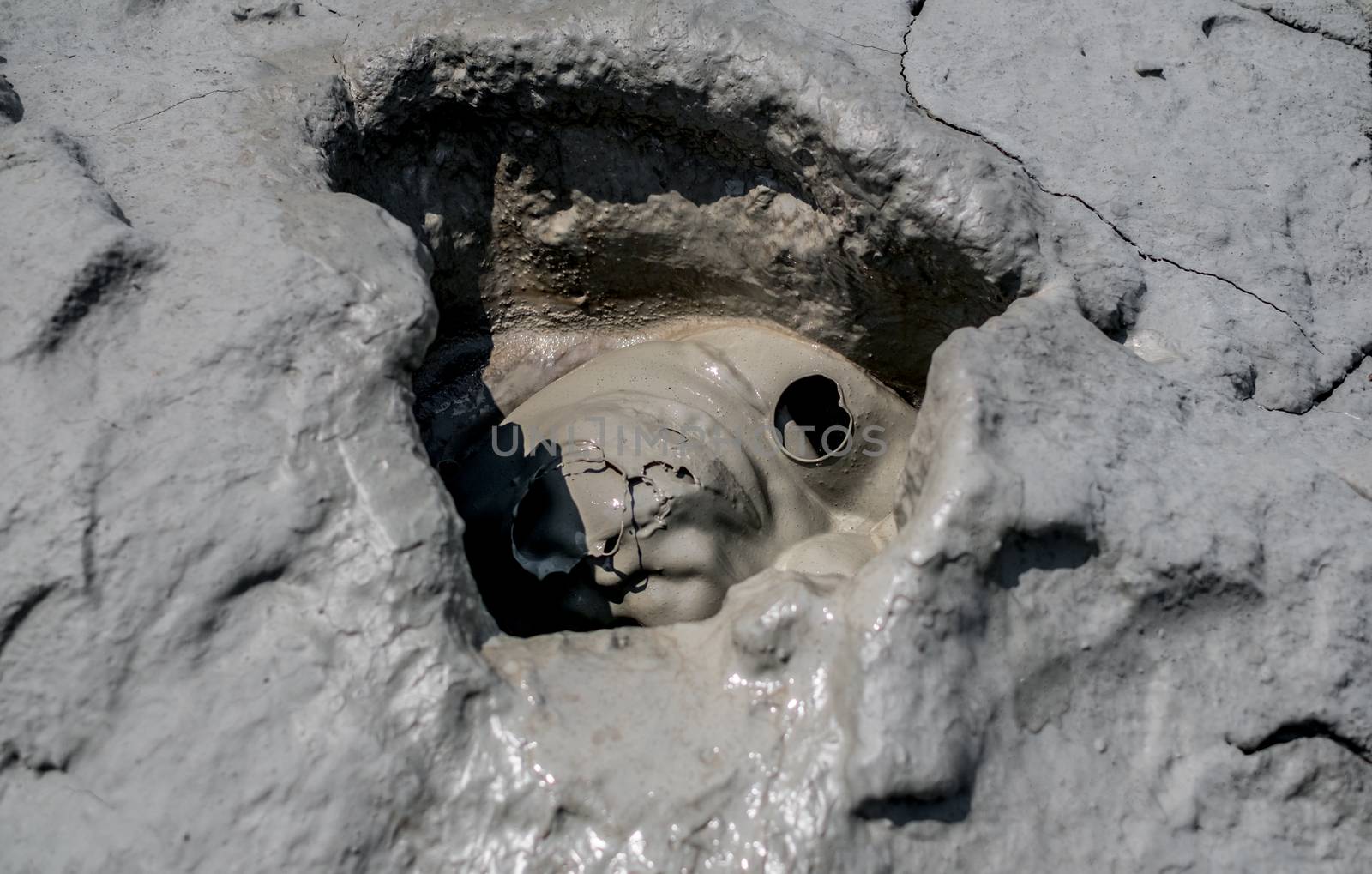 Close-up of bubbling mud in crater of mud volcano in Buzau county, Romania