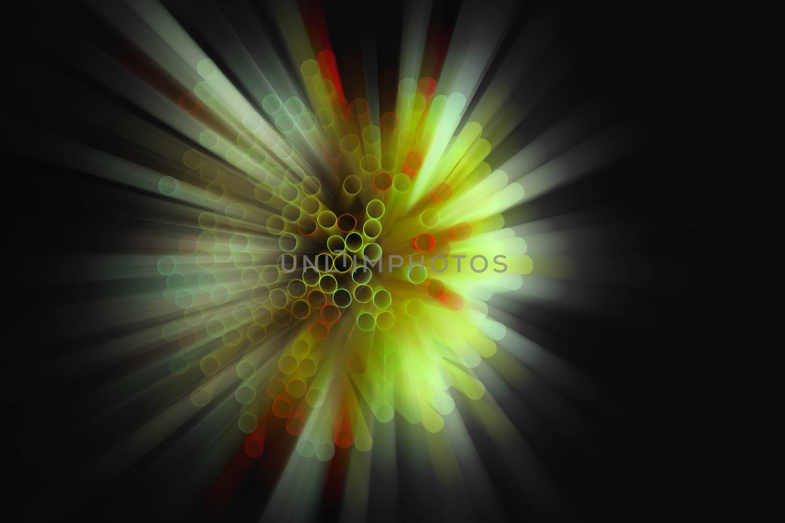 colored plastic drinking straws on black background