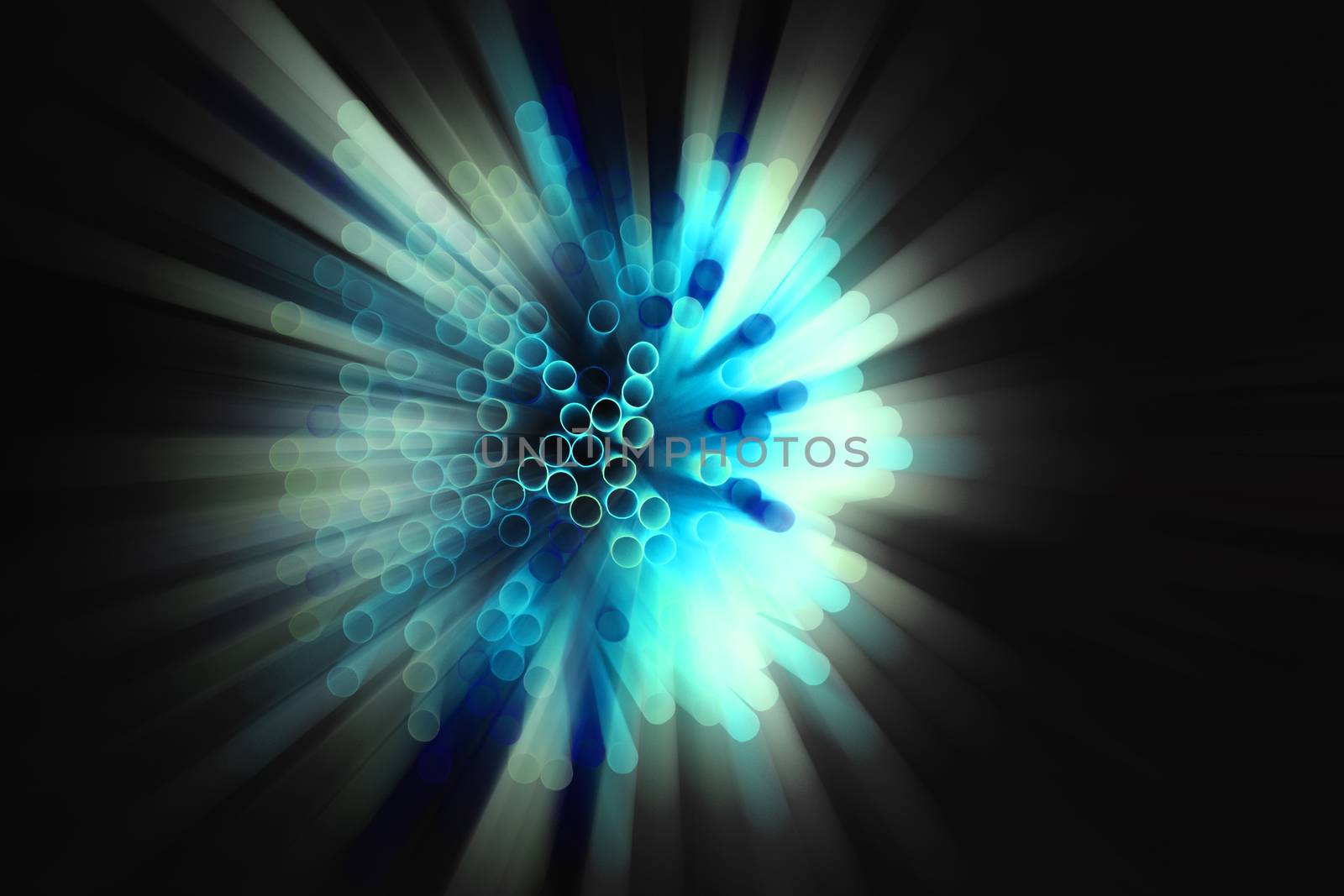 colored plastic drinking straws on black background