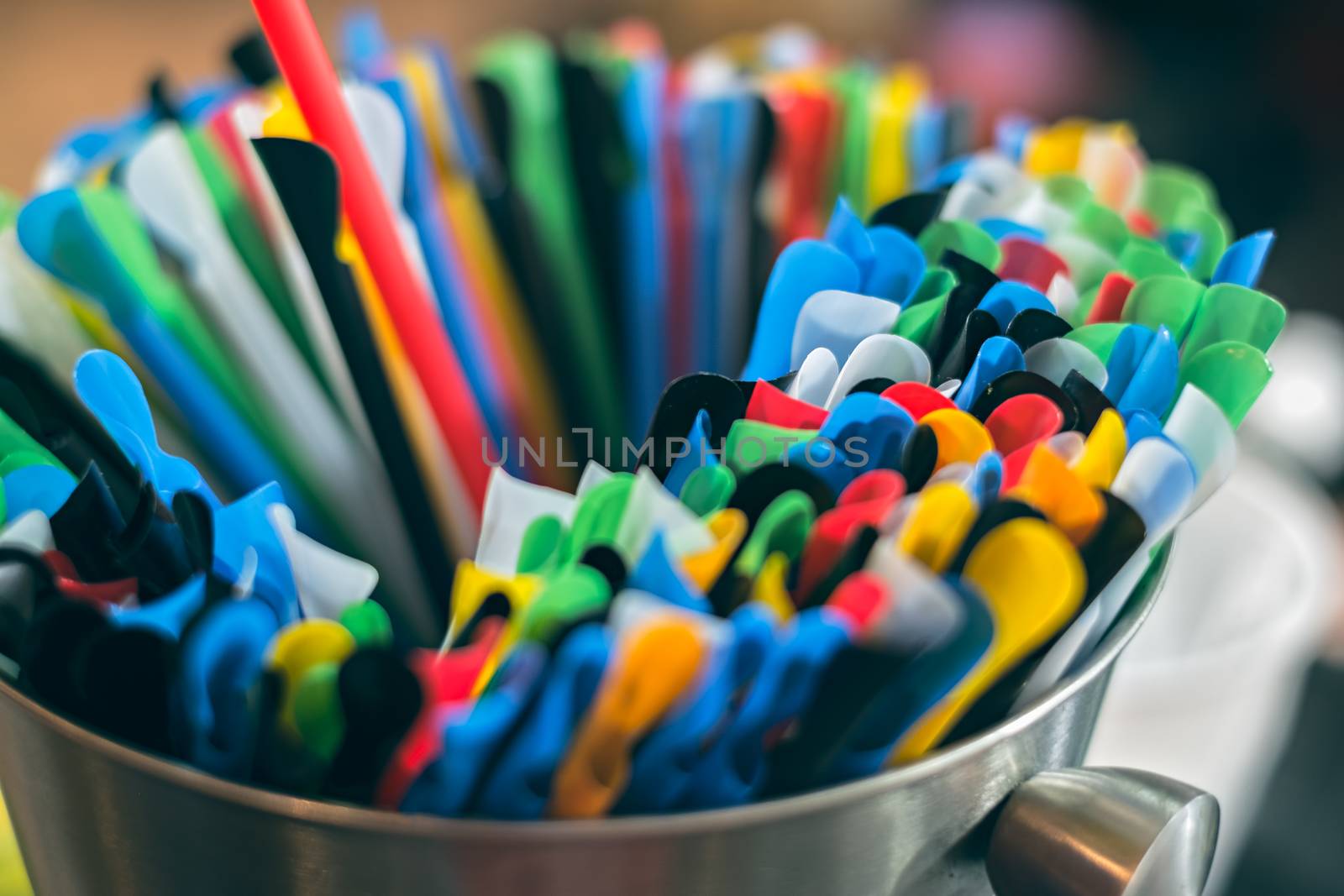 Colorful plastic drinking straws in aluminium bowl