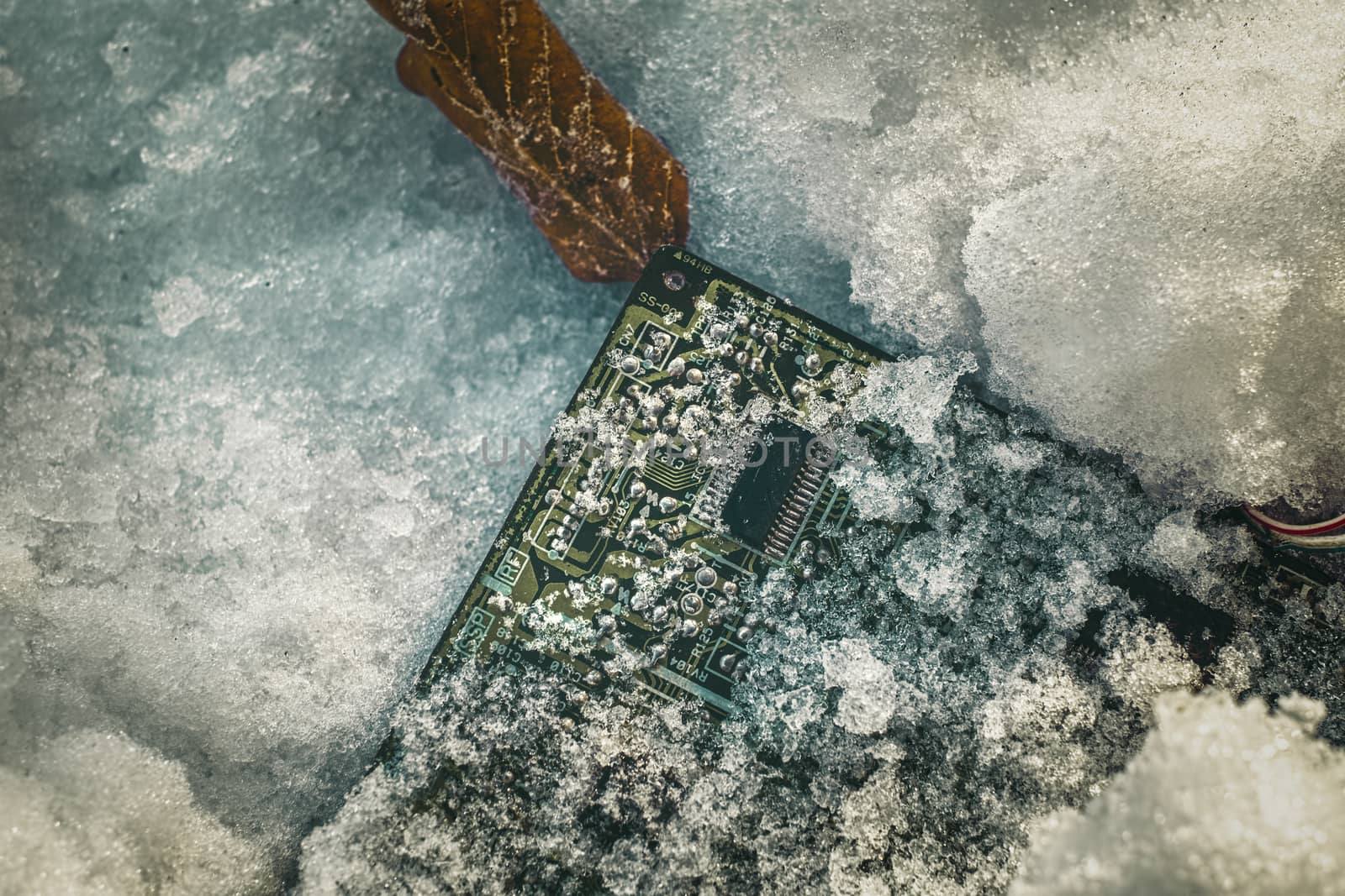 circuit board with microprocessor covered by snow