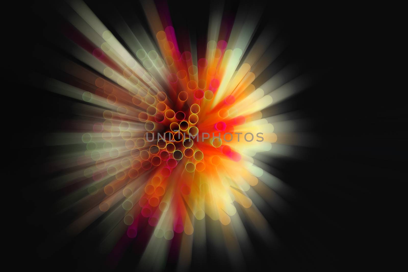 colored plastic drinking straws on black background