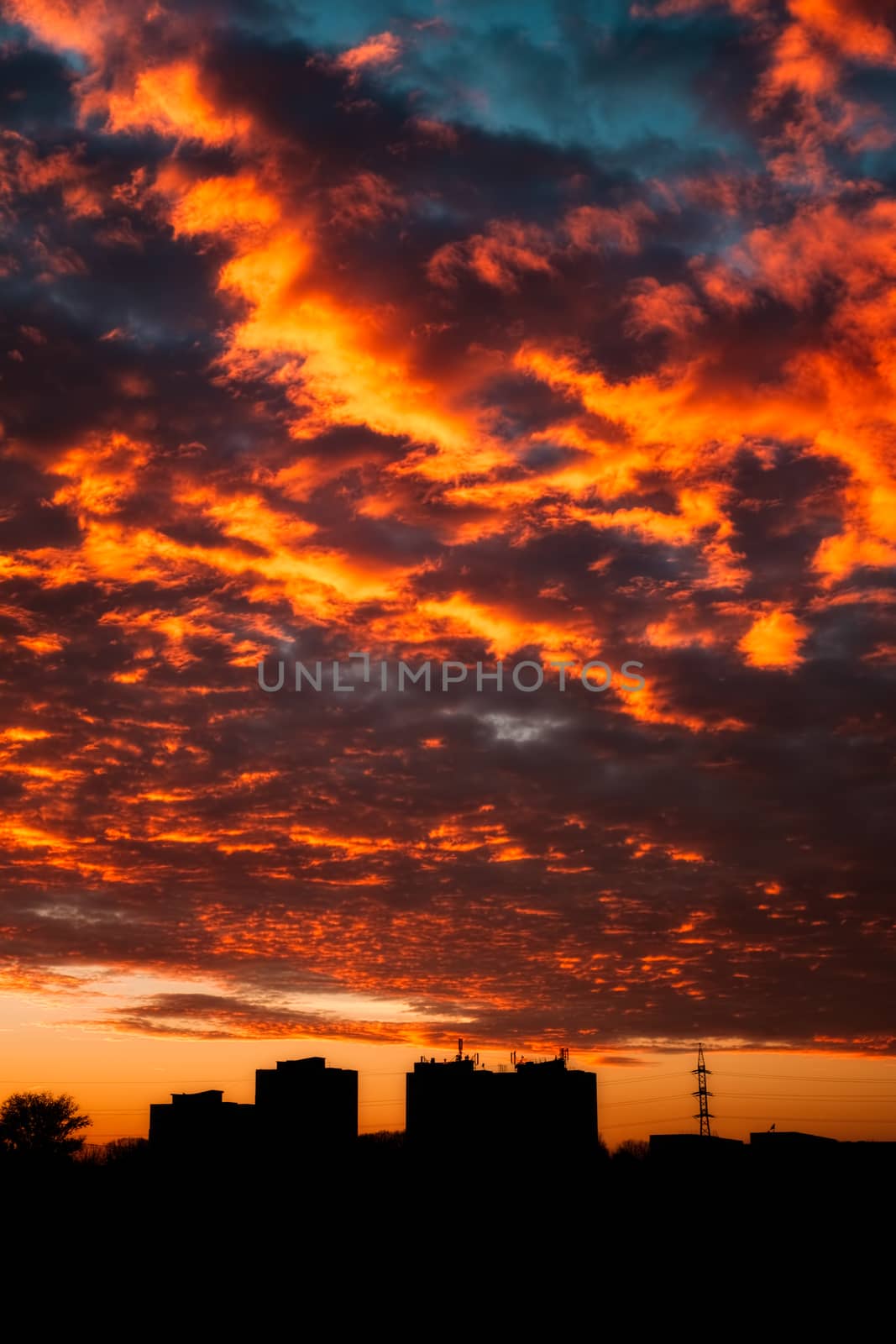 Drammatic evening sky over city scape silhouette